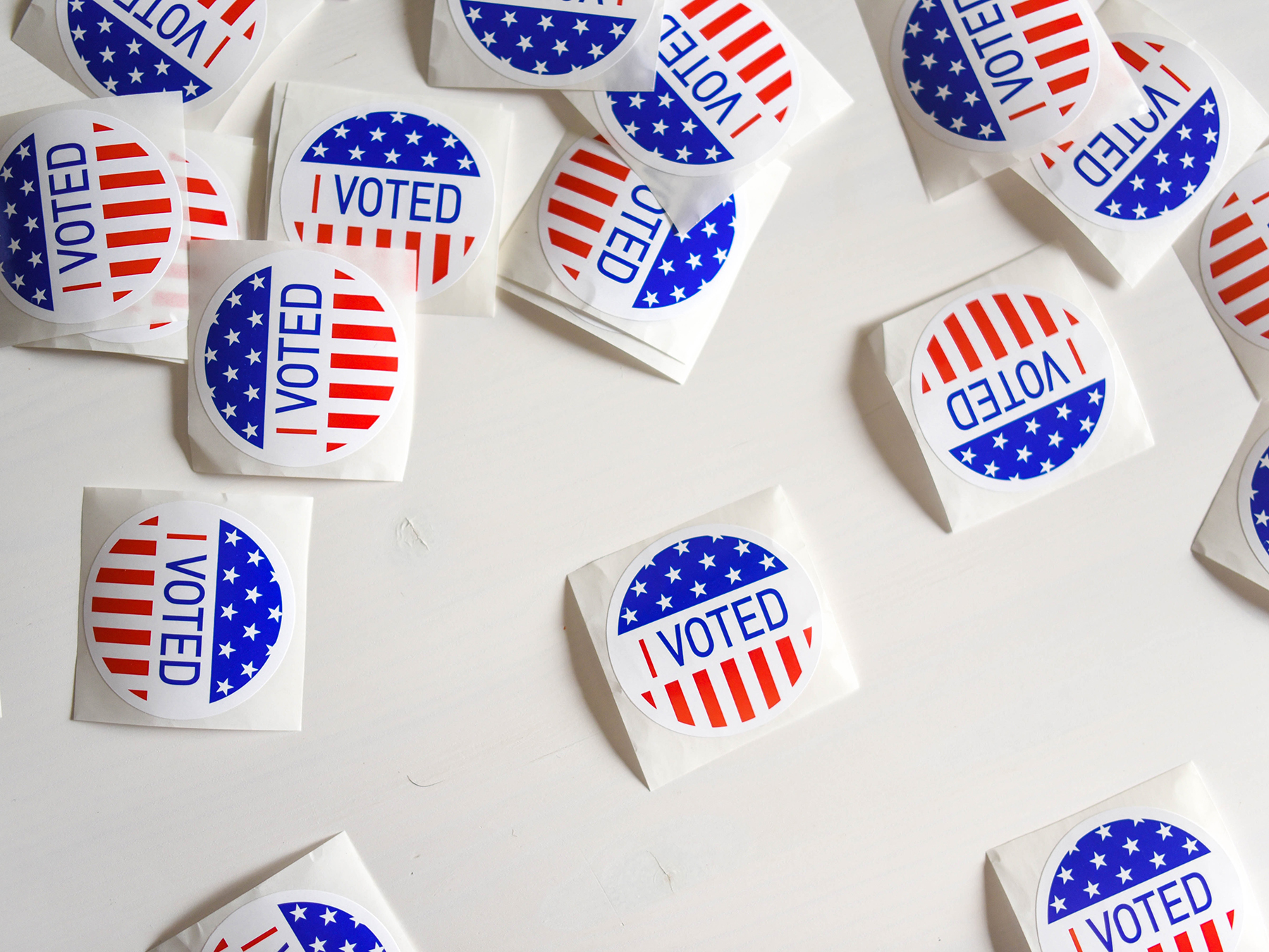 Several "I Voted" stickers laid out on a table