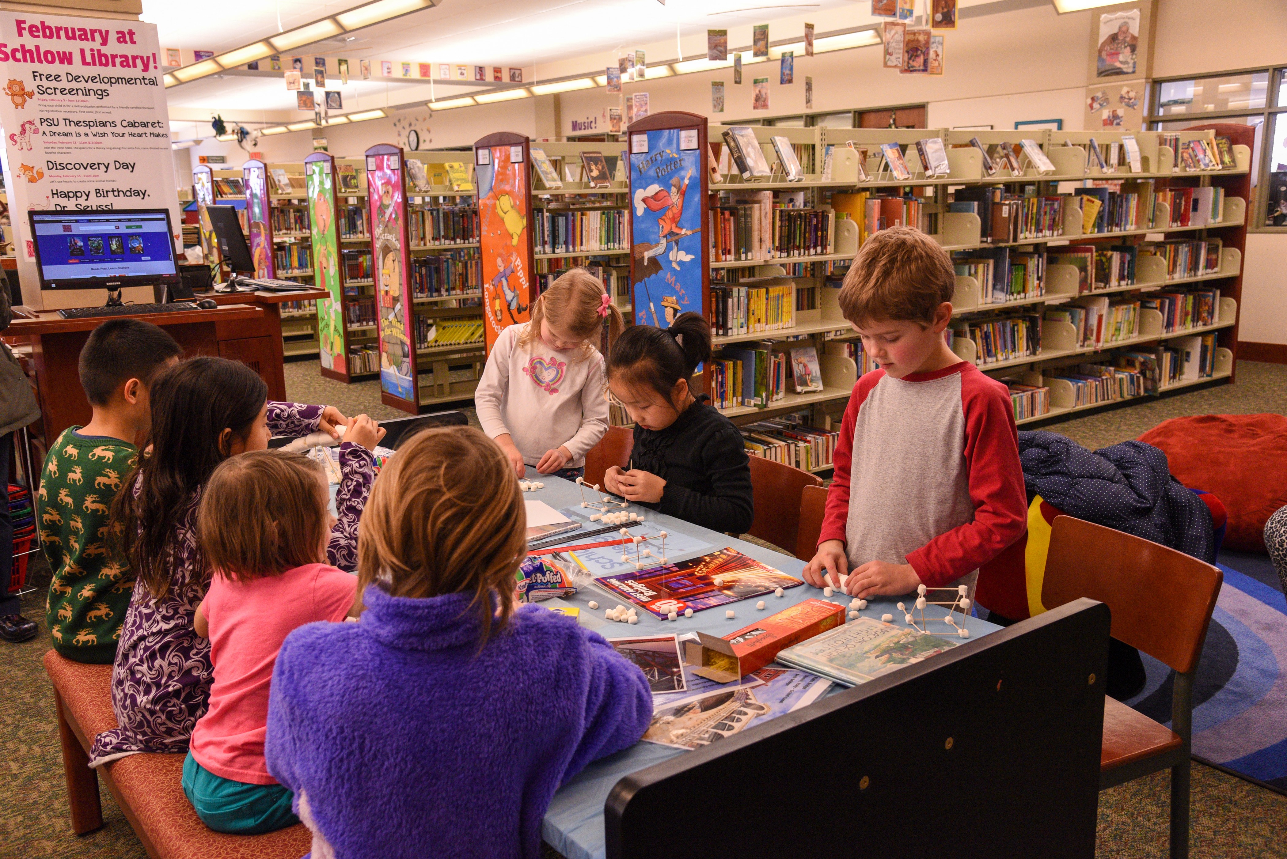 Kids at a table in a library