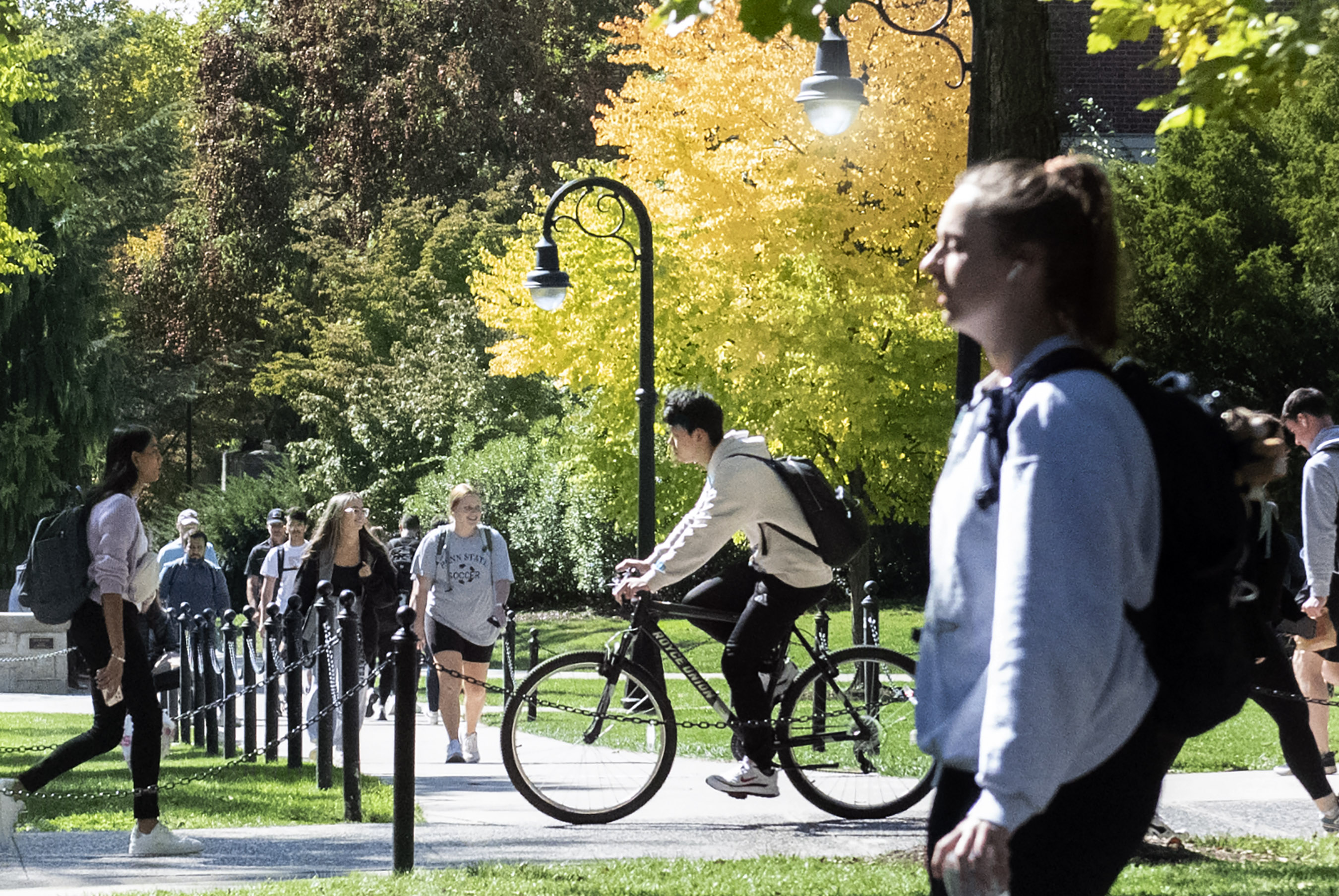 students biking and walkin on University Park campus