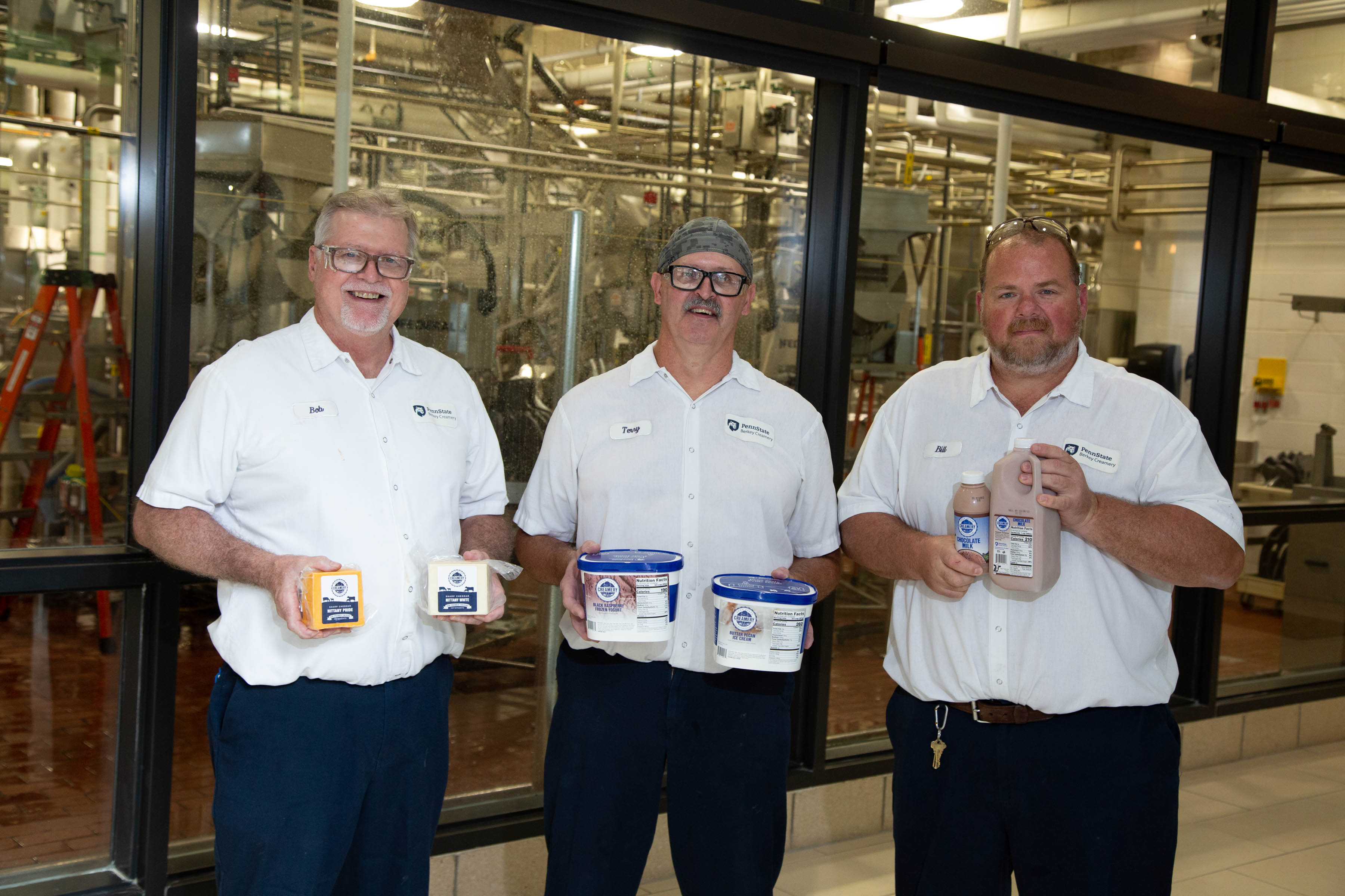 Terry Grove, Bill Kurtz, and Bob Rosenberry holding up this year's and last's winning products.