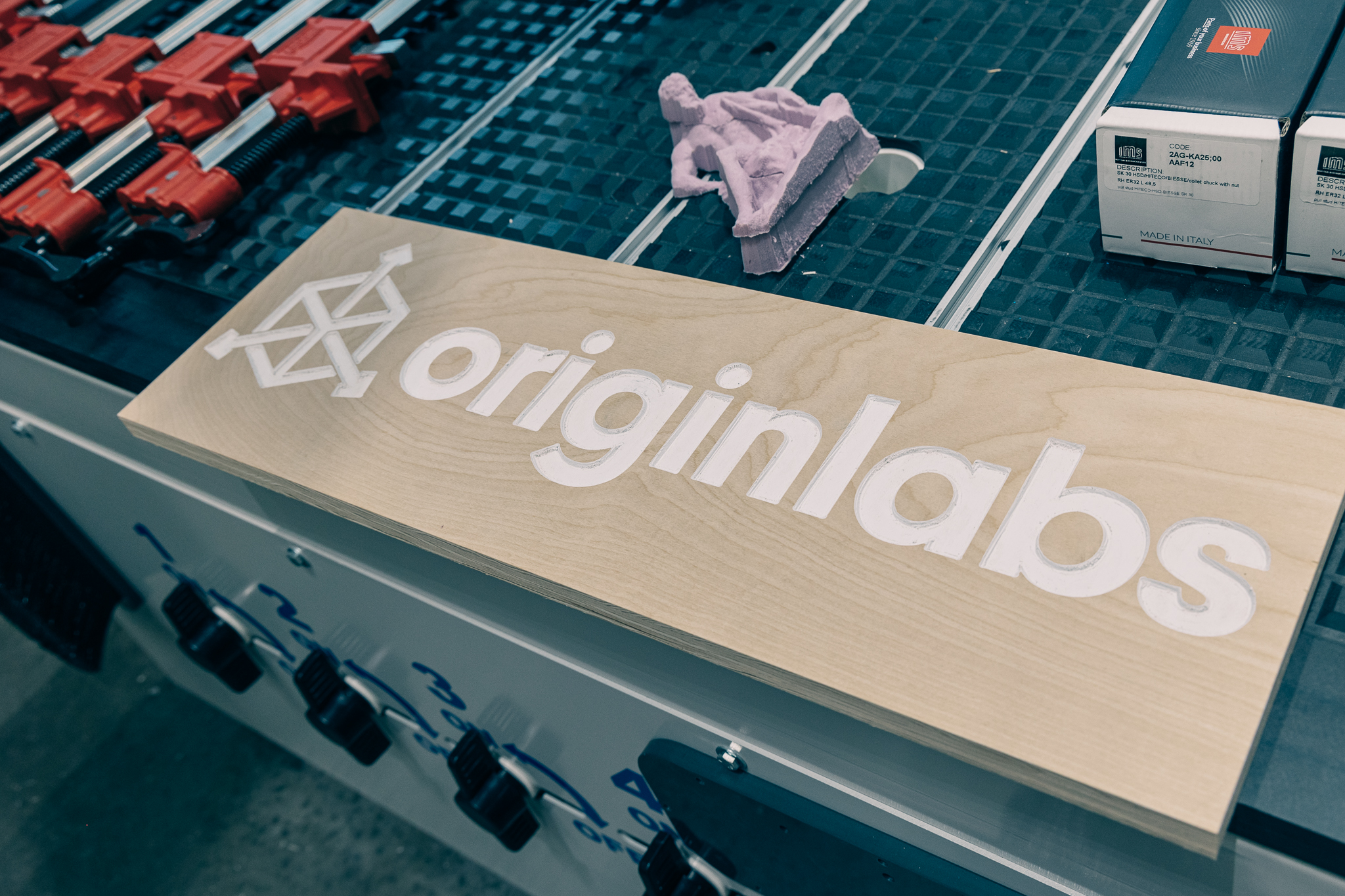 The OriginLabs logo is engraved on a wooden sign