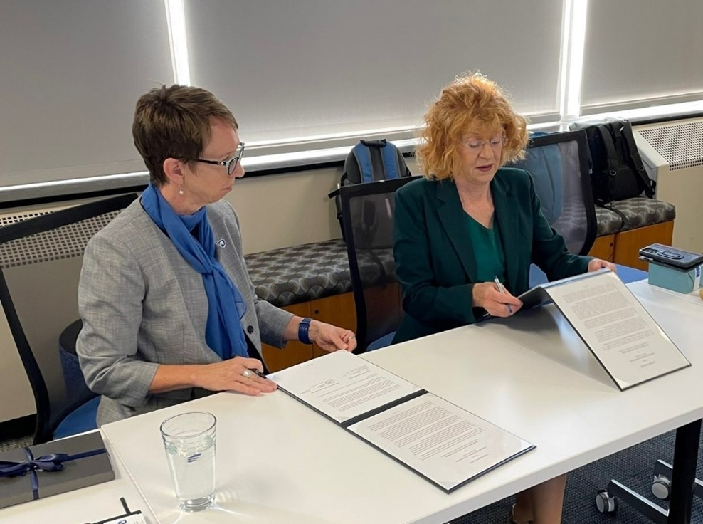 Two women reading over documents