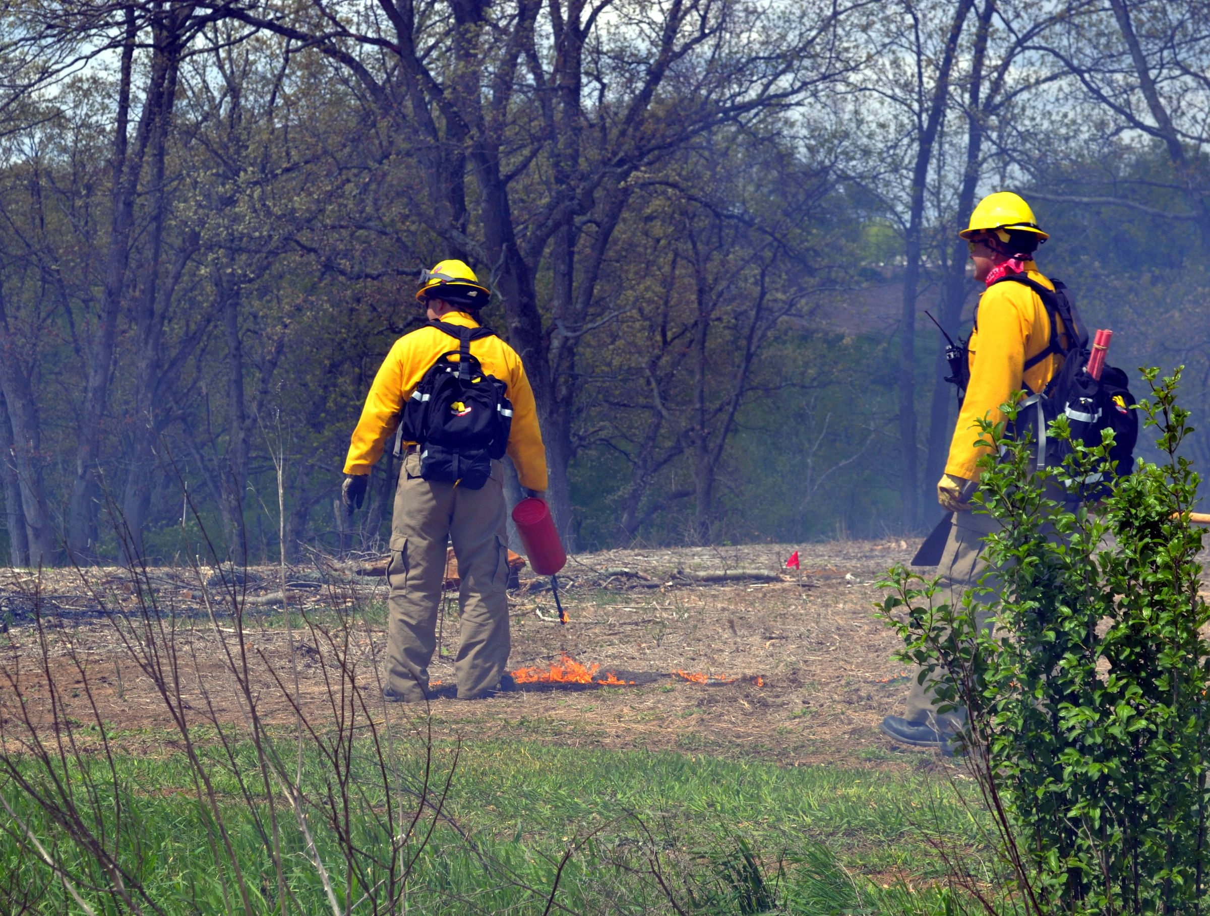 Crew members monitor a prescribed burn at the Arboretum at Penn State