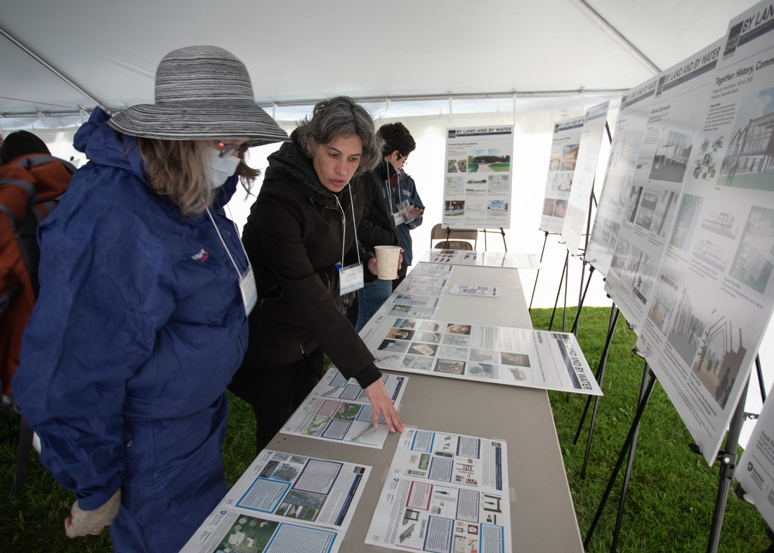 Lisa Iulo at center points to flood maps on a table in front of her to residents of Selinsgrove, Pennsylvania. 