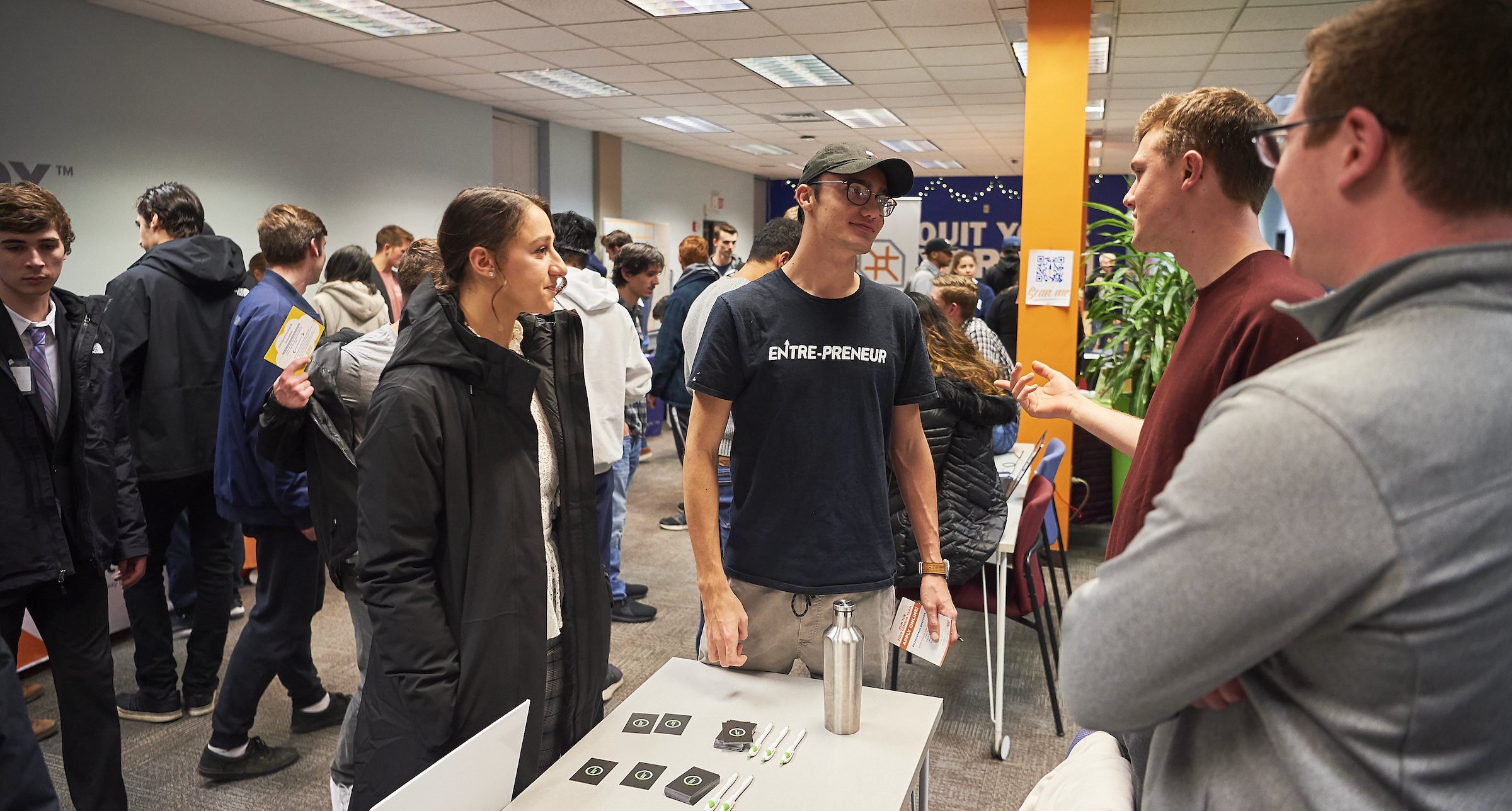 Group of students talking to each other during a tabling event