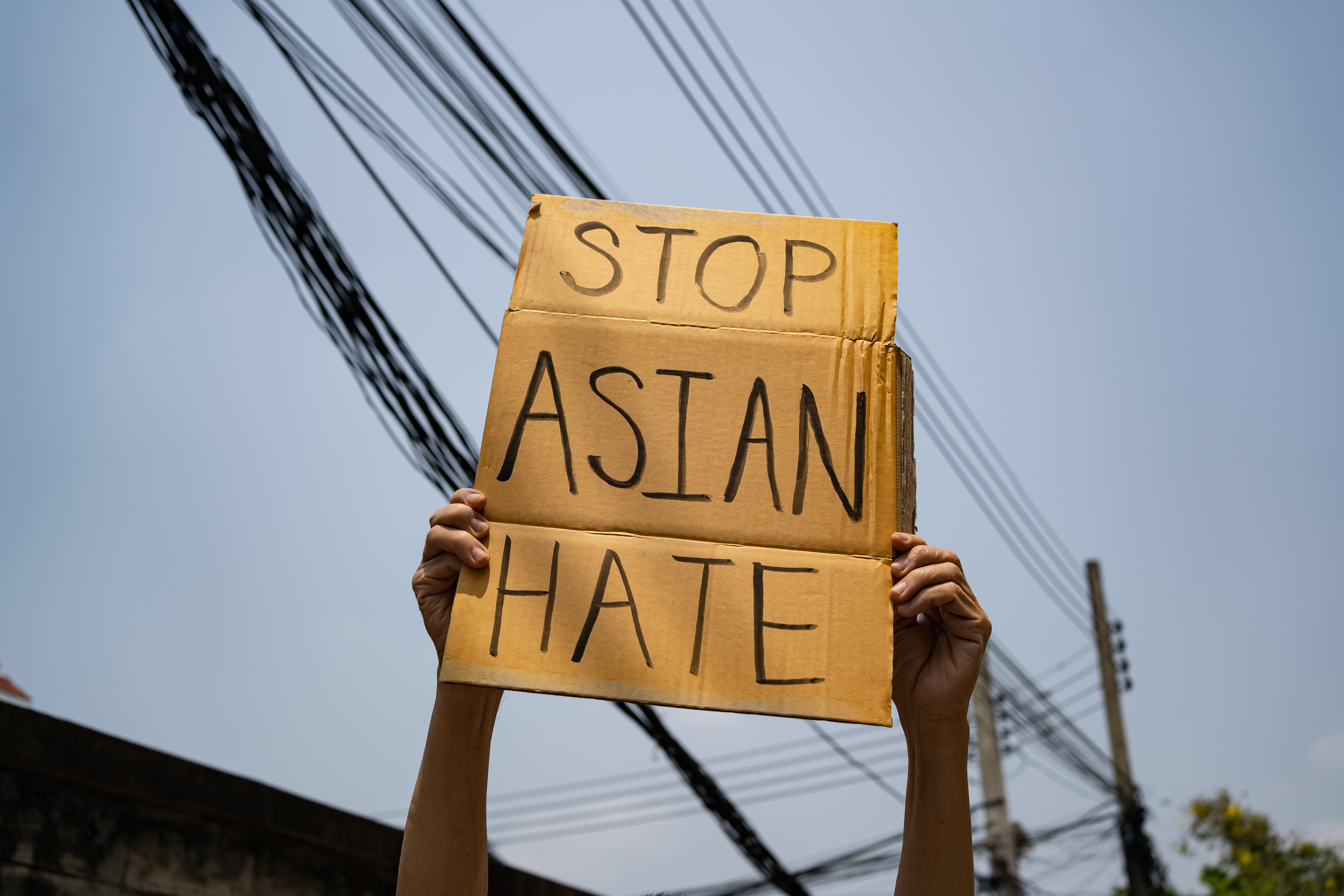 Cardboard sign that says: "Stop Asian Hate" 