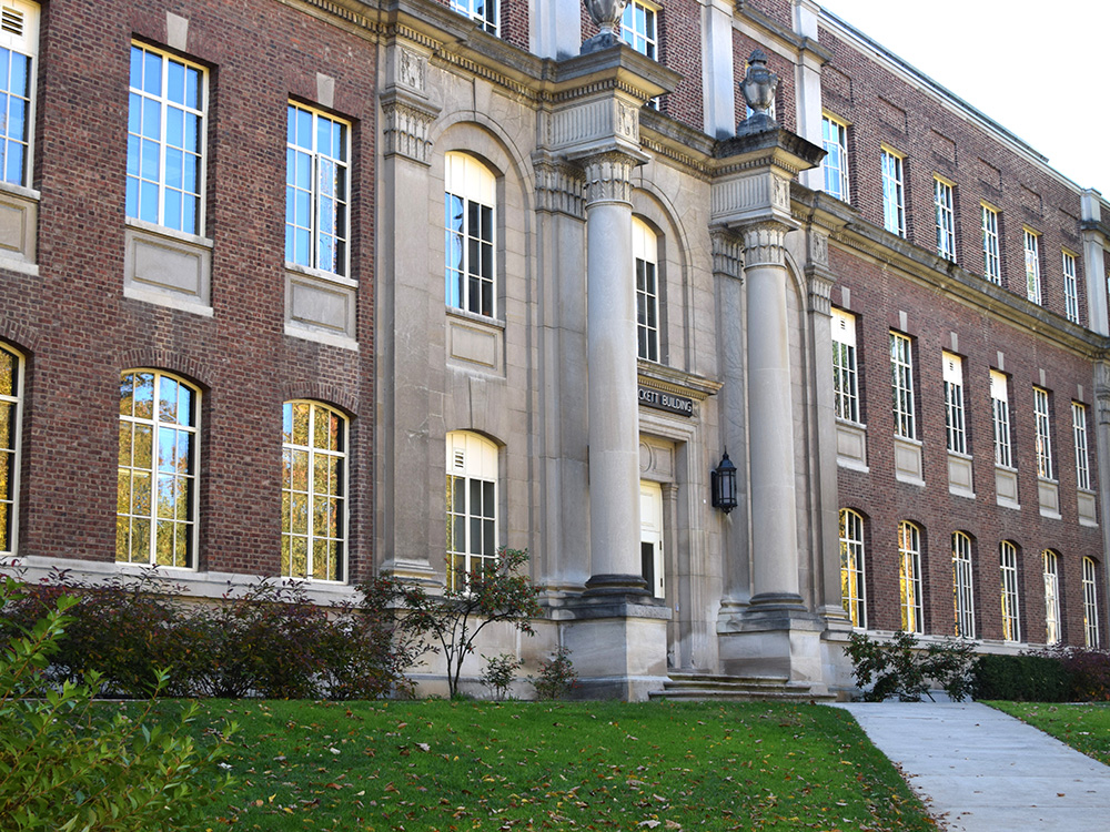 a brick building with two large pillars.