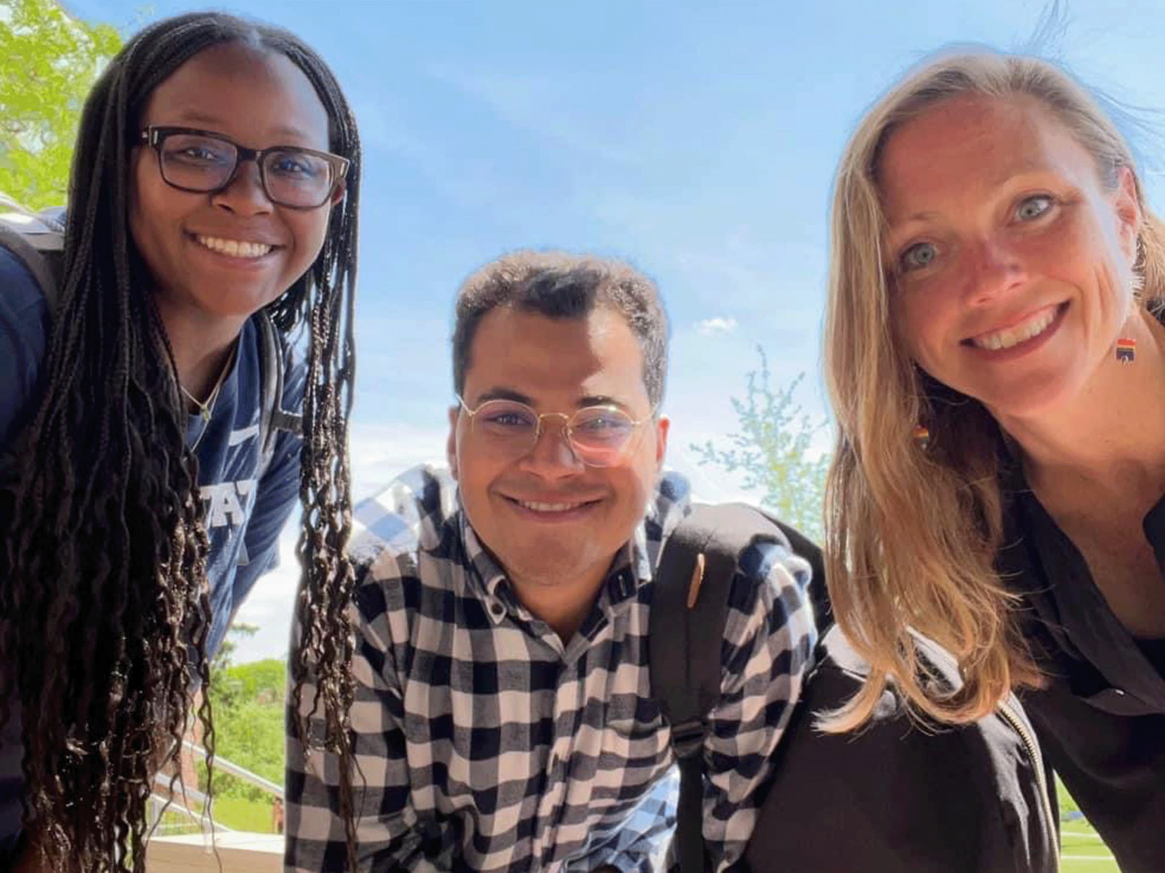 Members of Students United Against Poverty smile for a closeup photo