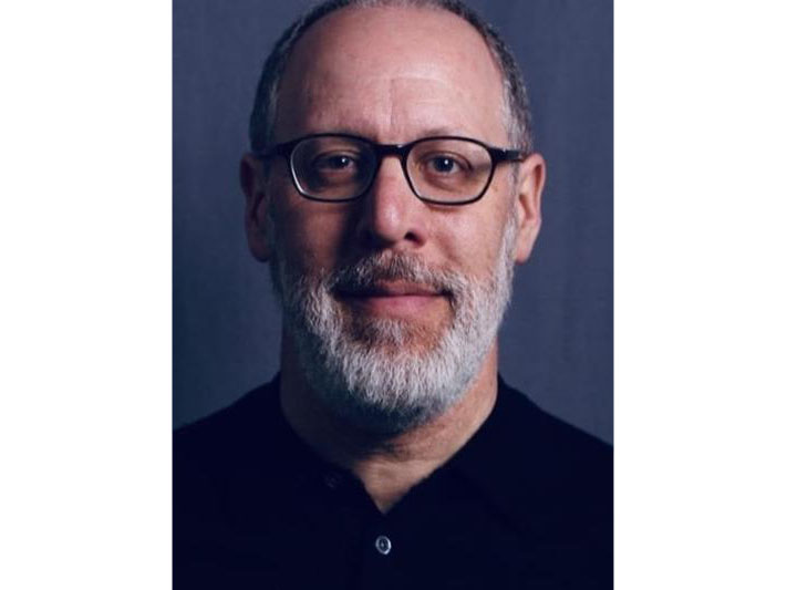 head shot of a man with a beard and glasses