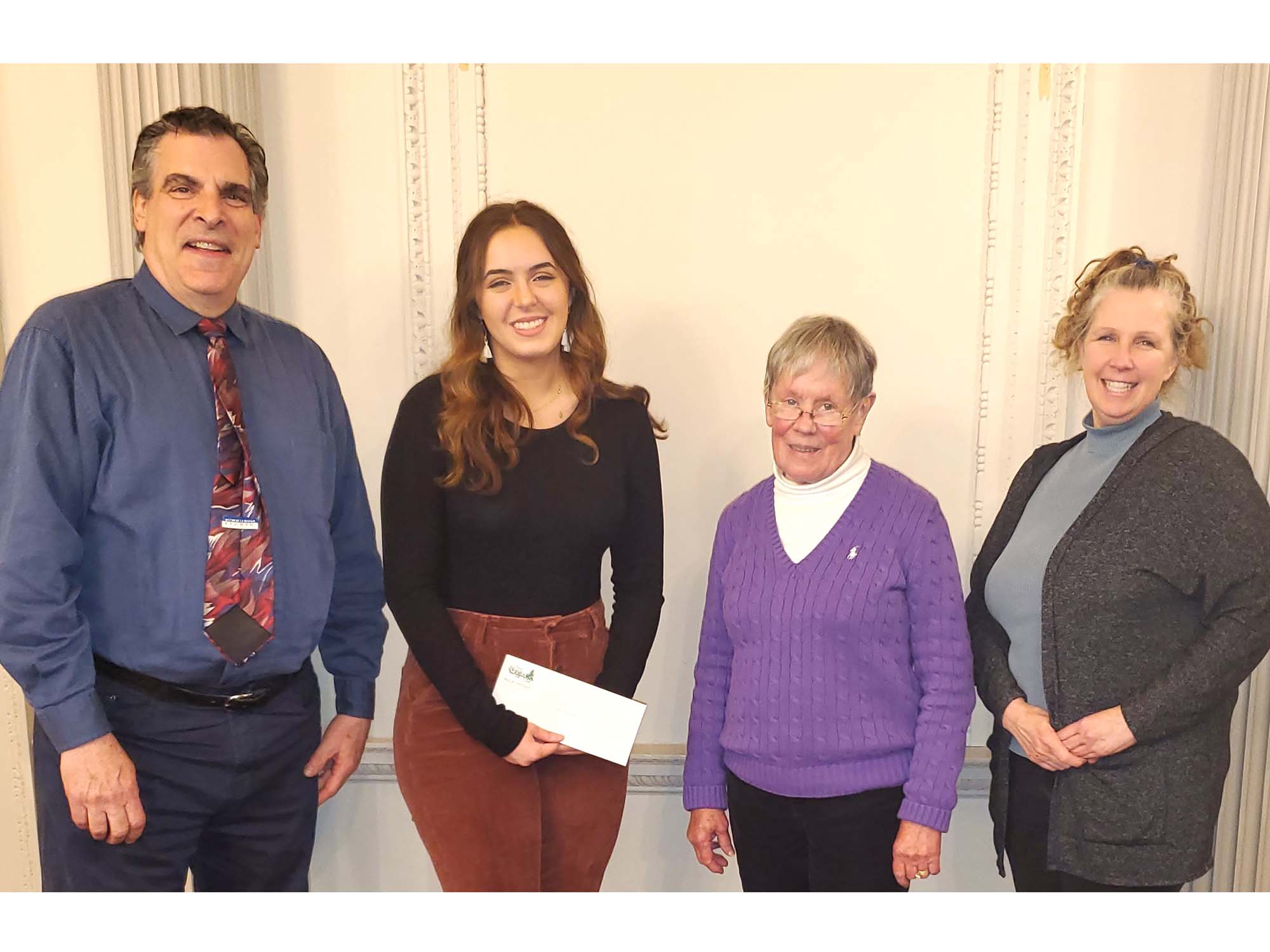 Four people standing together for a check presentation