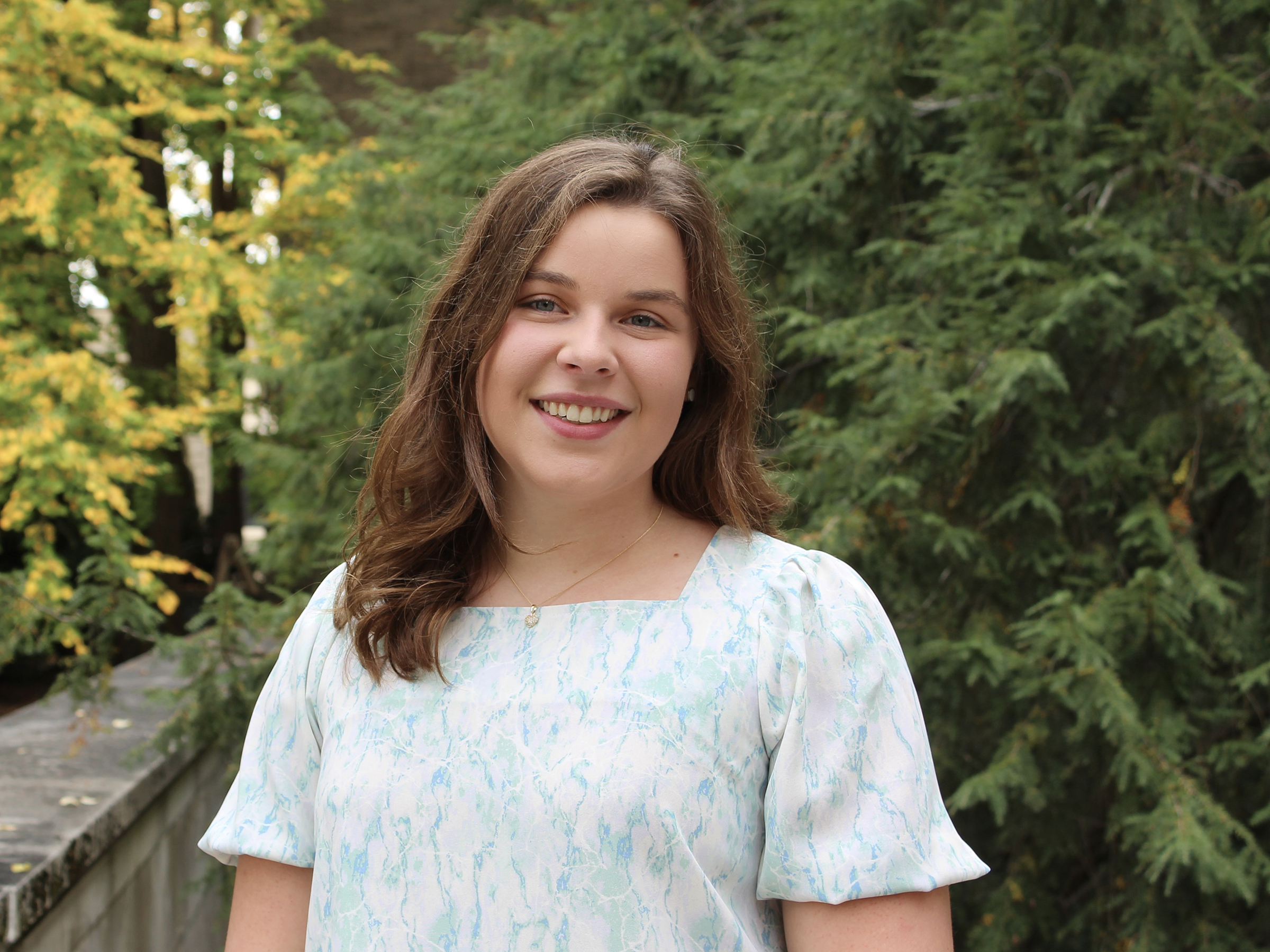 Rachel Blansfield, the fall 2022 student marshal for the College of the Liberal Arts, stands outside Sparks Building.