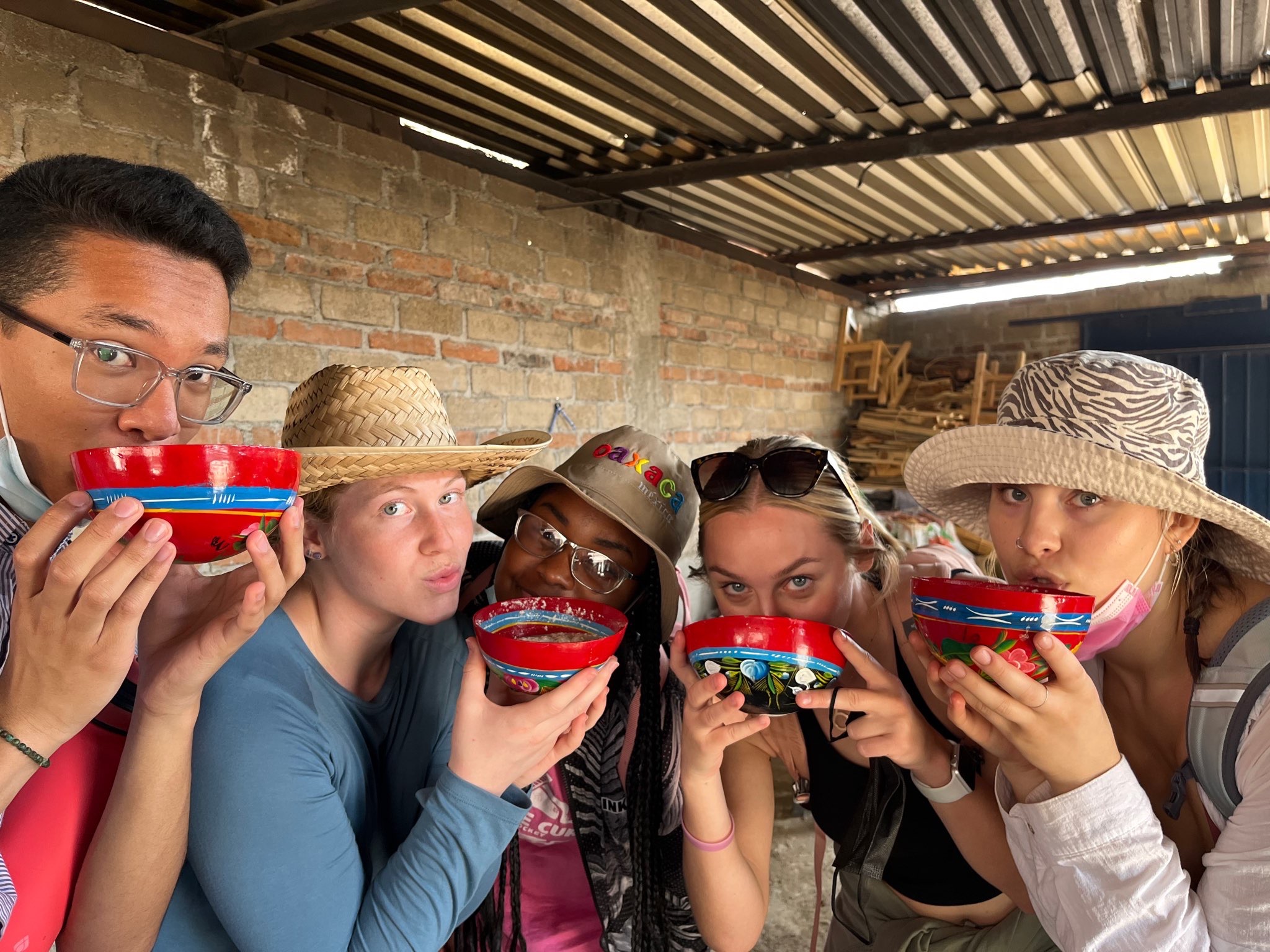 Students holding hand-painted bowls