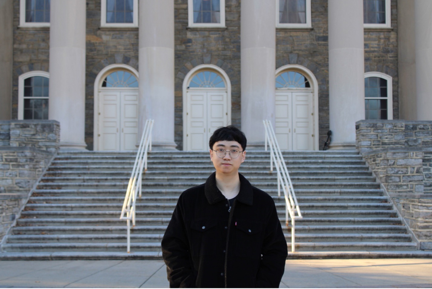 Junyu Zhang in front of Old Main steps