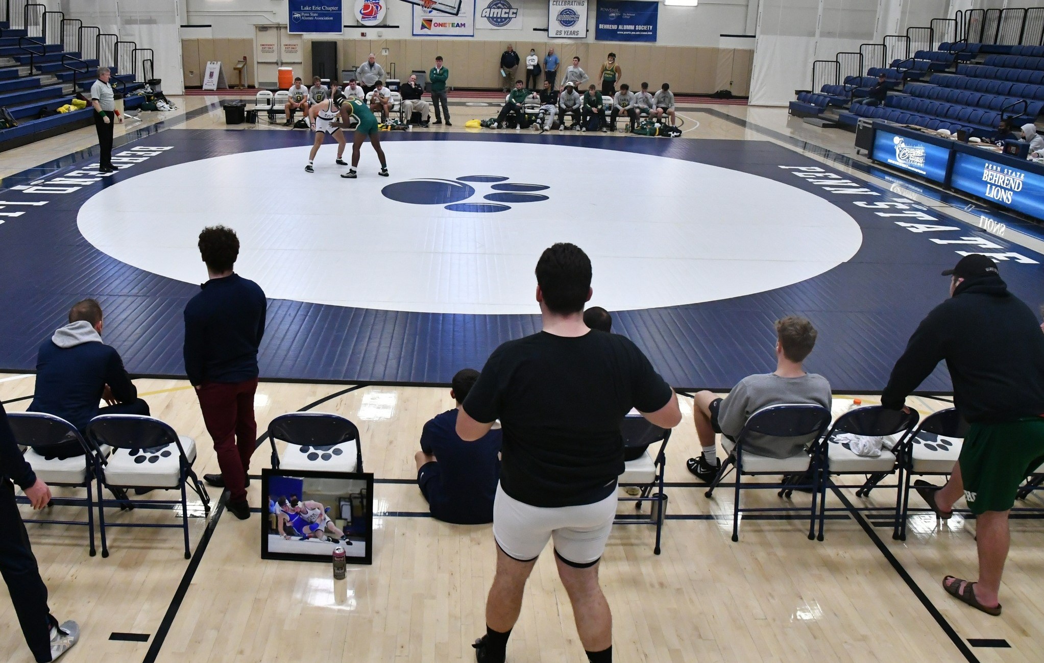 Two wrestlers grapple during a match at Penn State Behrend