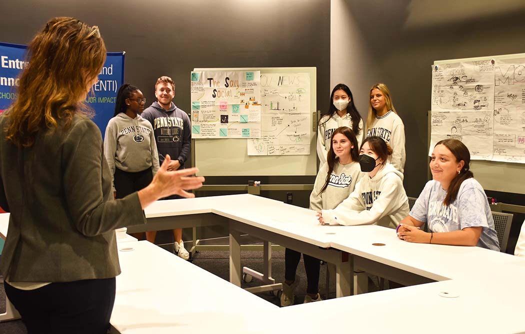 Students sitting around a conference table talking with a faculty member