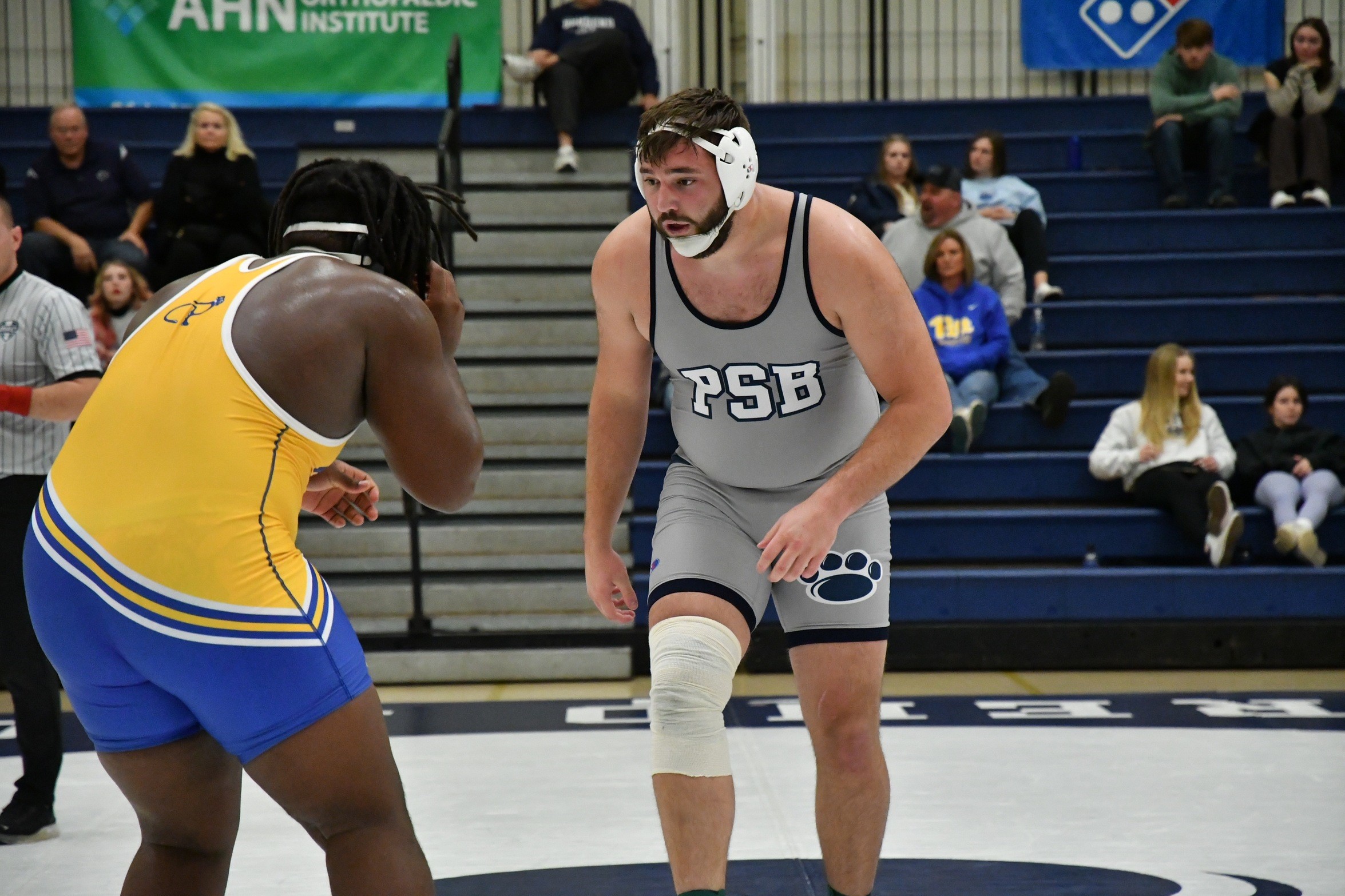 Penn State Behrend wrestler Kyle Trim faces off against an opponent.