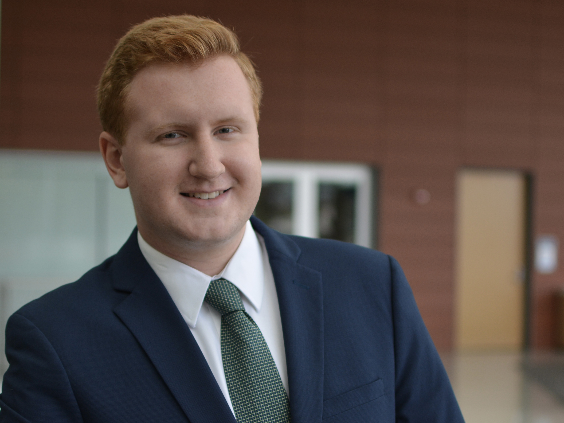 Liberal Arts student Jacob Roth leans against a railing in the HUB-Robeson Center.