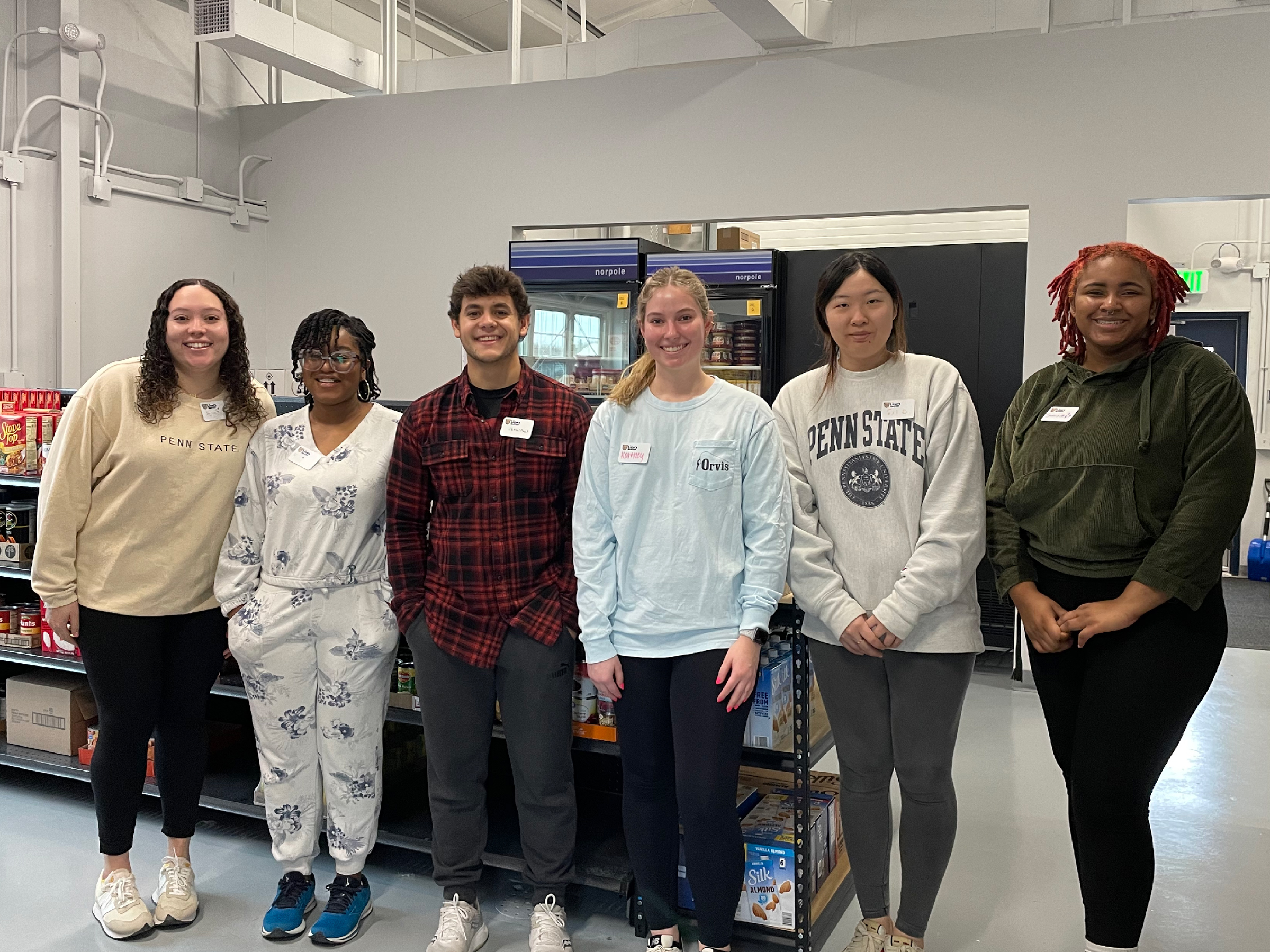 A group of student volunteers pose inside the Lion's Pantry