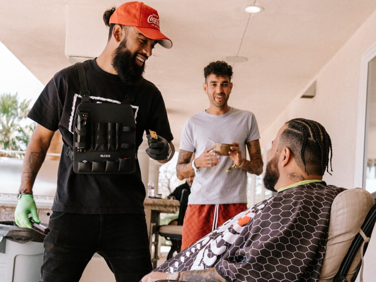 A barber cuts a customer's hair using the Rig, SLCKR's flagship product.