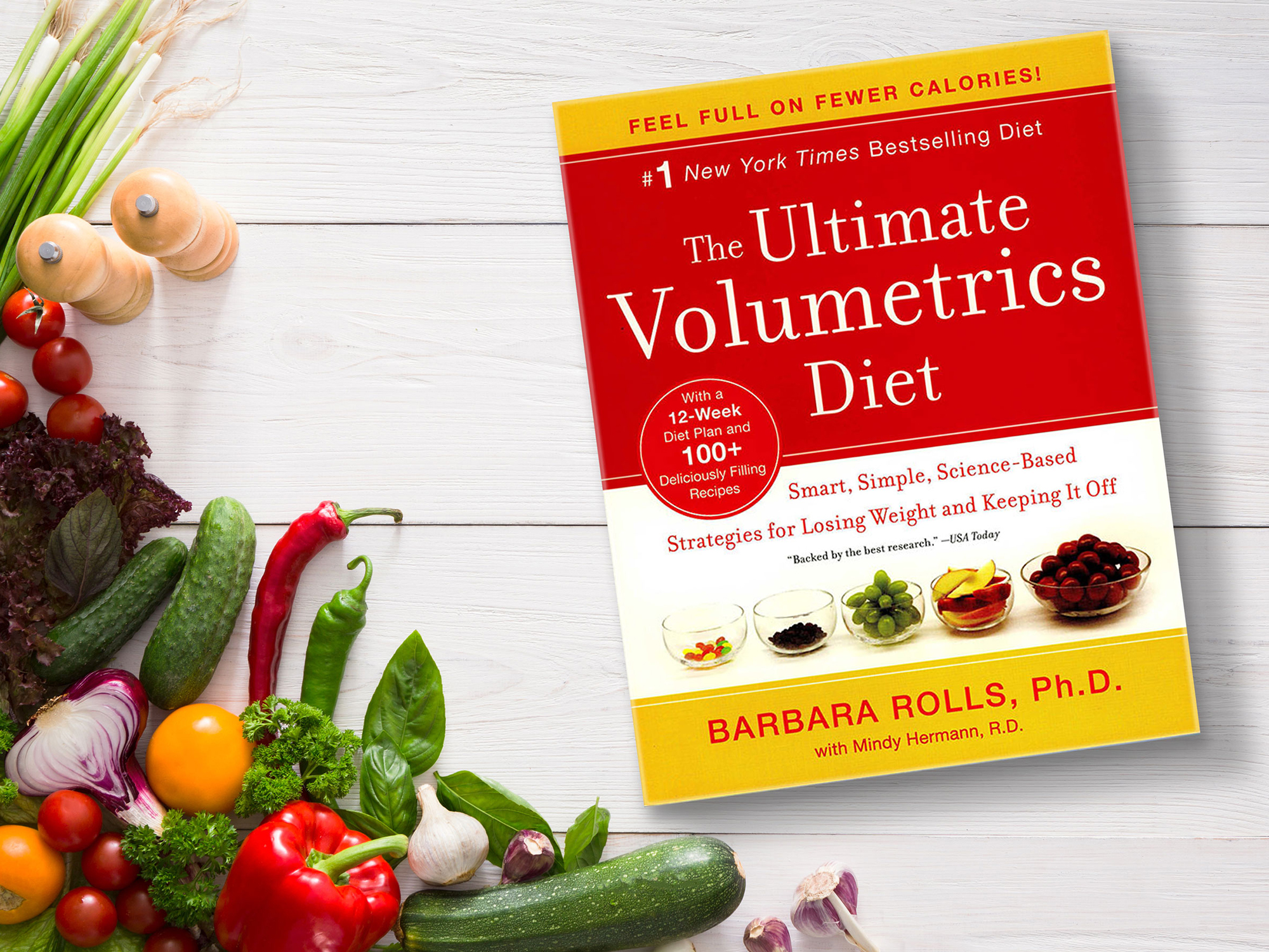 The book 'Ultimate Volumetrics' on a white background with many vegetables around