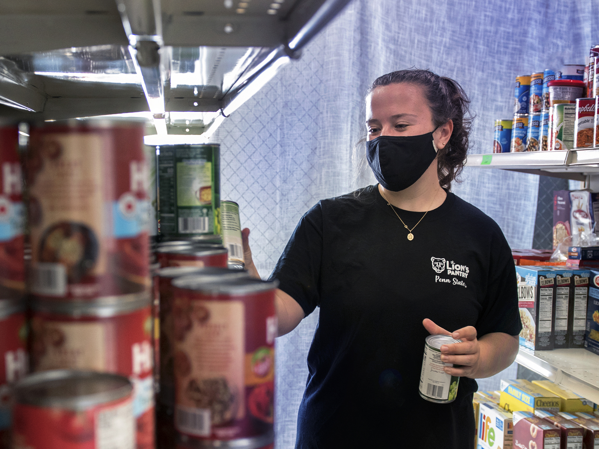 Emily Griffin stocking shelves at Lions Pantry