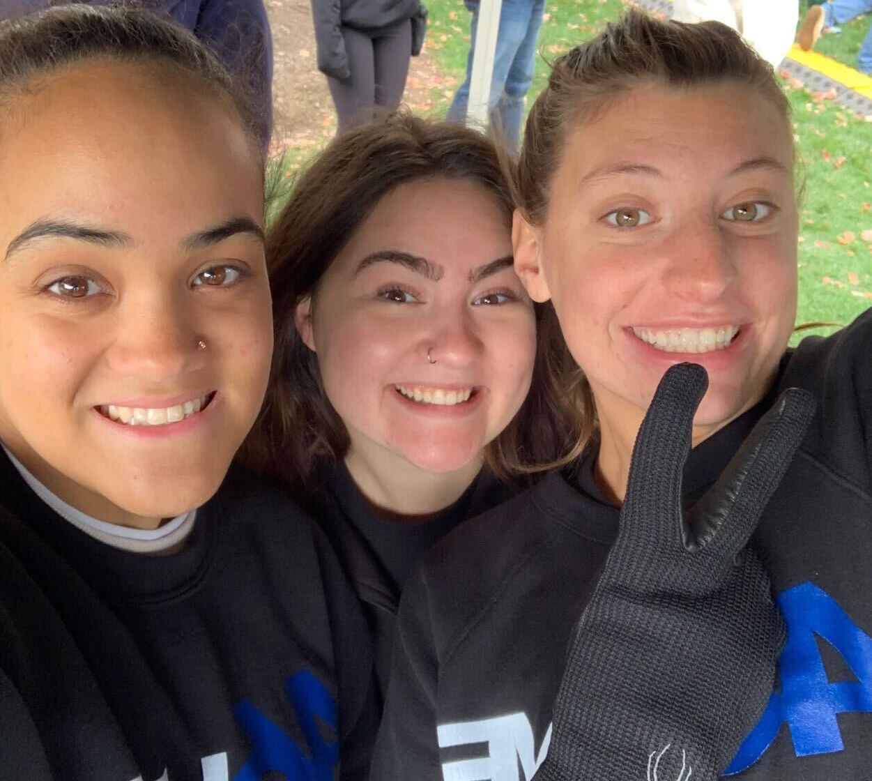 Three smiling students side by side