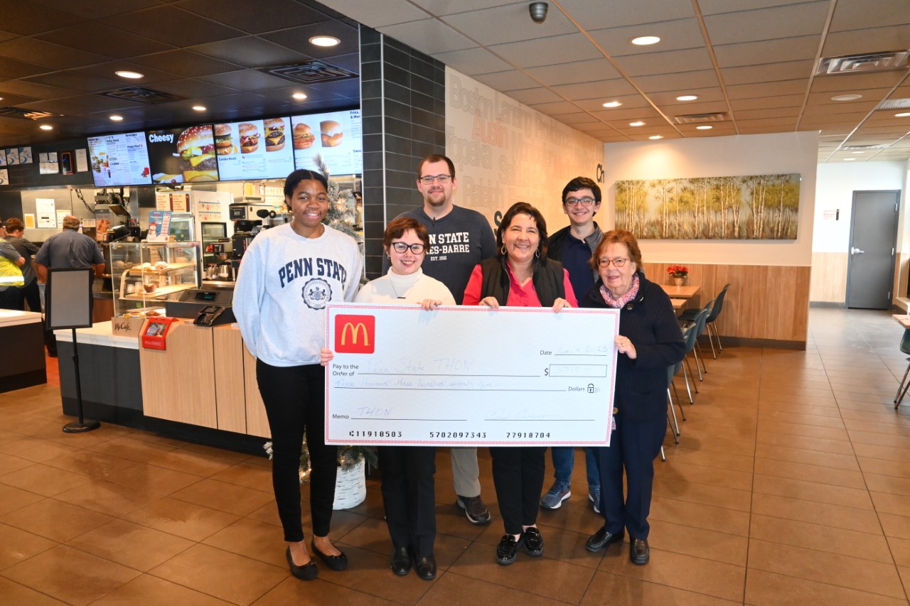 A group of people for a check presentation