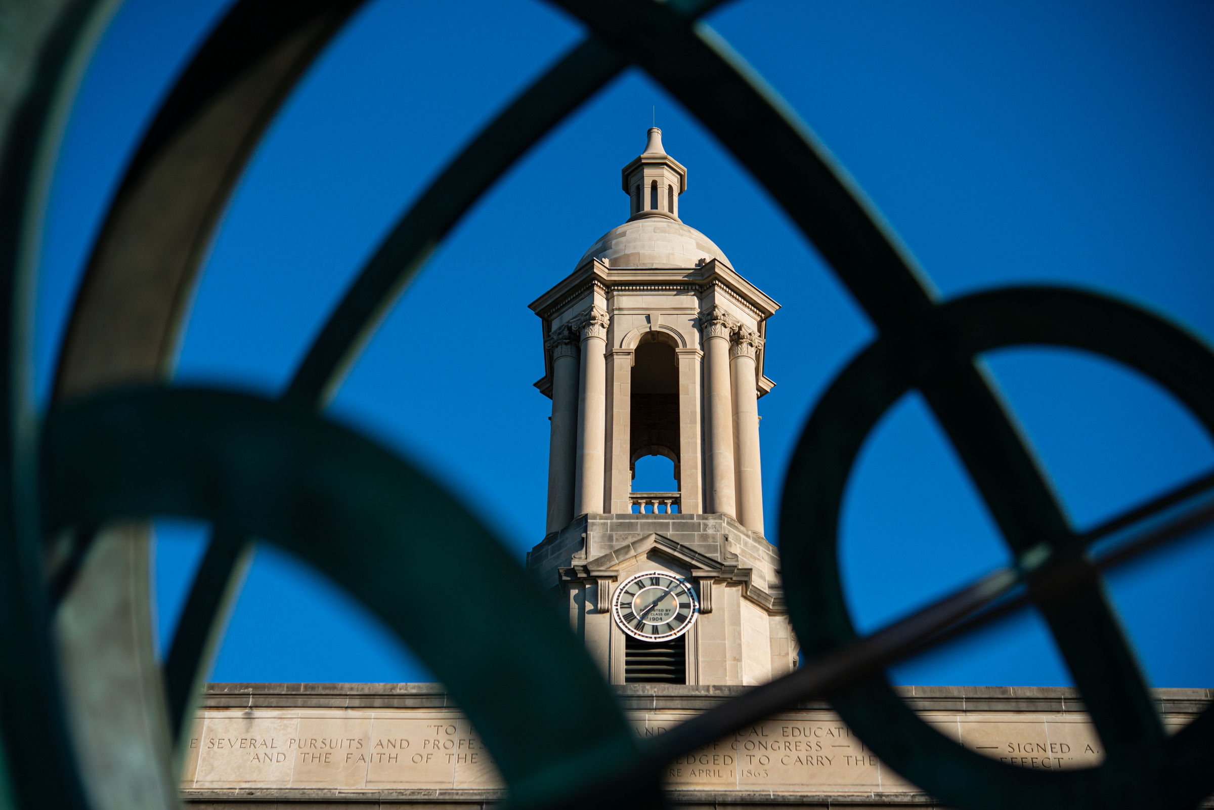 Old Main bell tower seen through armillary sphere sculpture