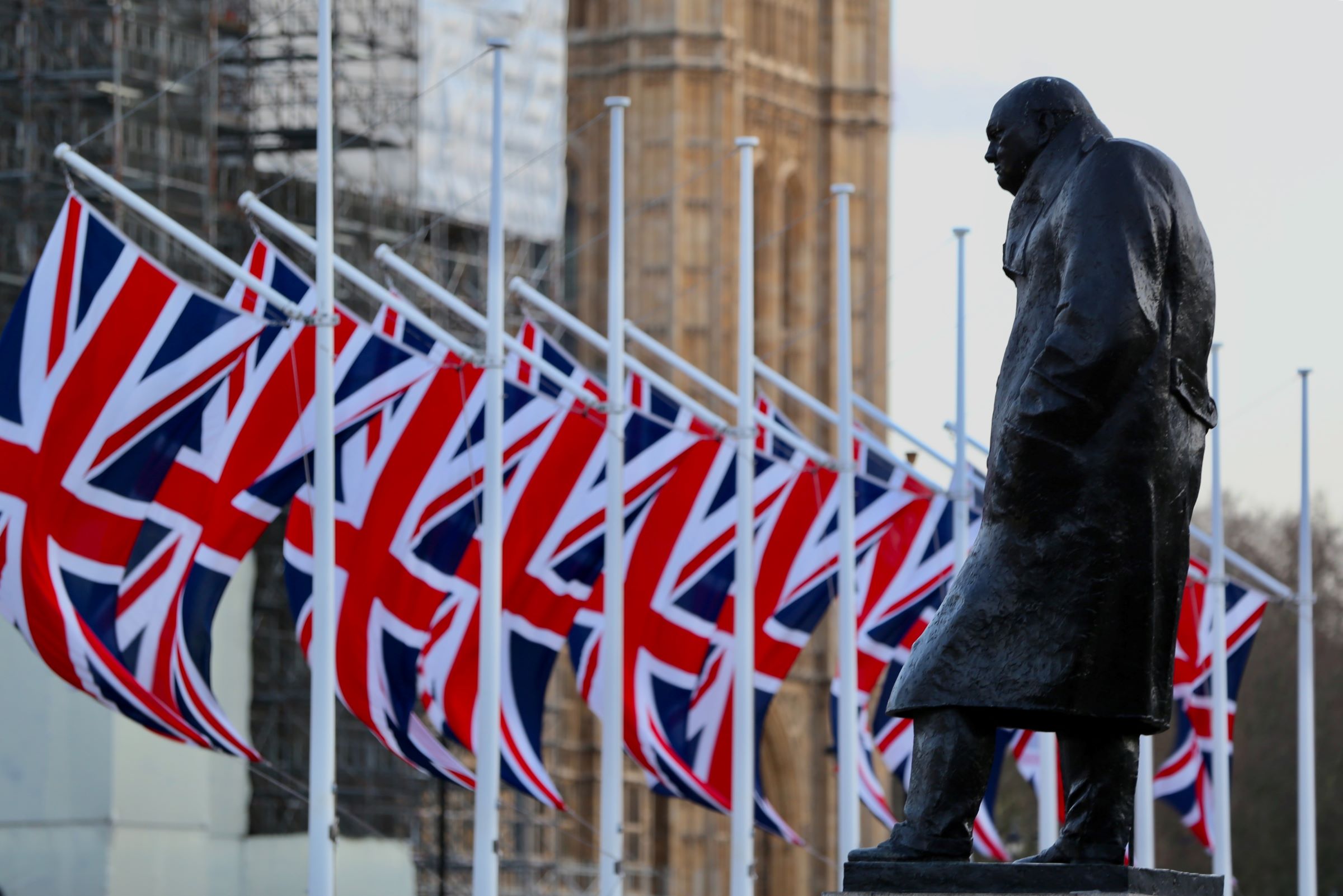 Statue of Winston Churchill in front of Union Jack Flags