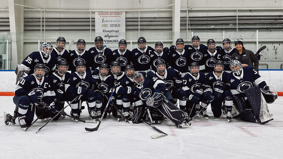 Women's ice hockey team poses together in group photo