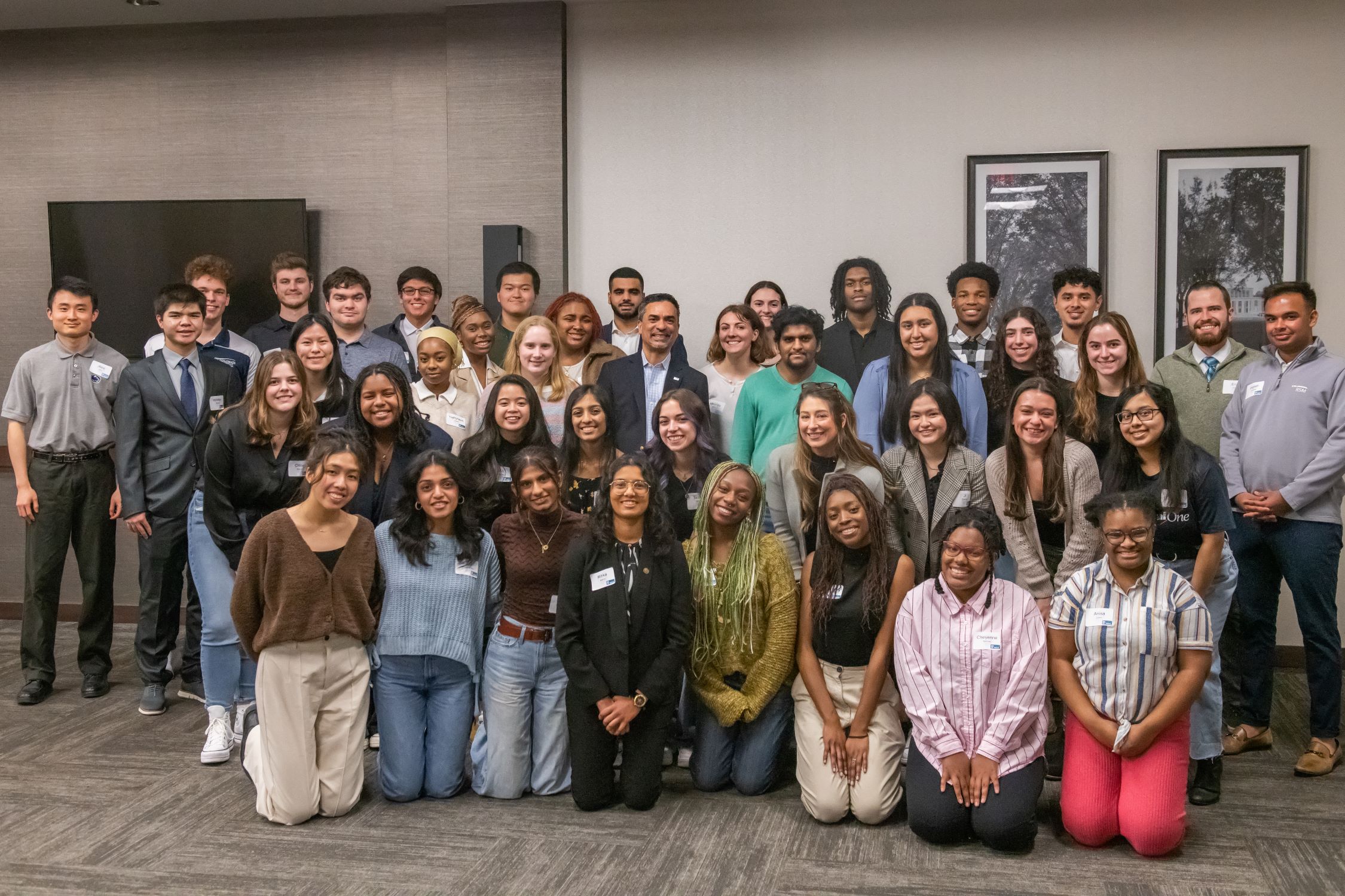 A large group of students in professional dress posing for a photo