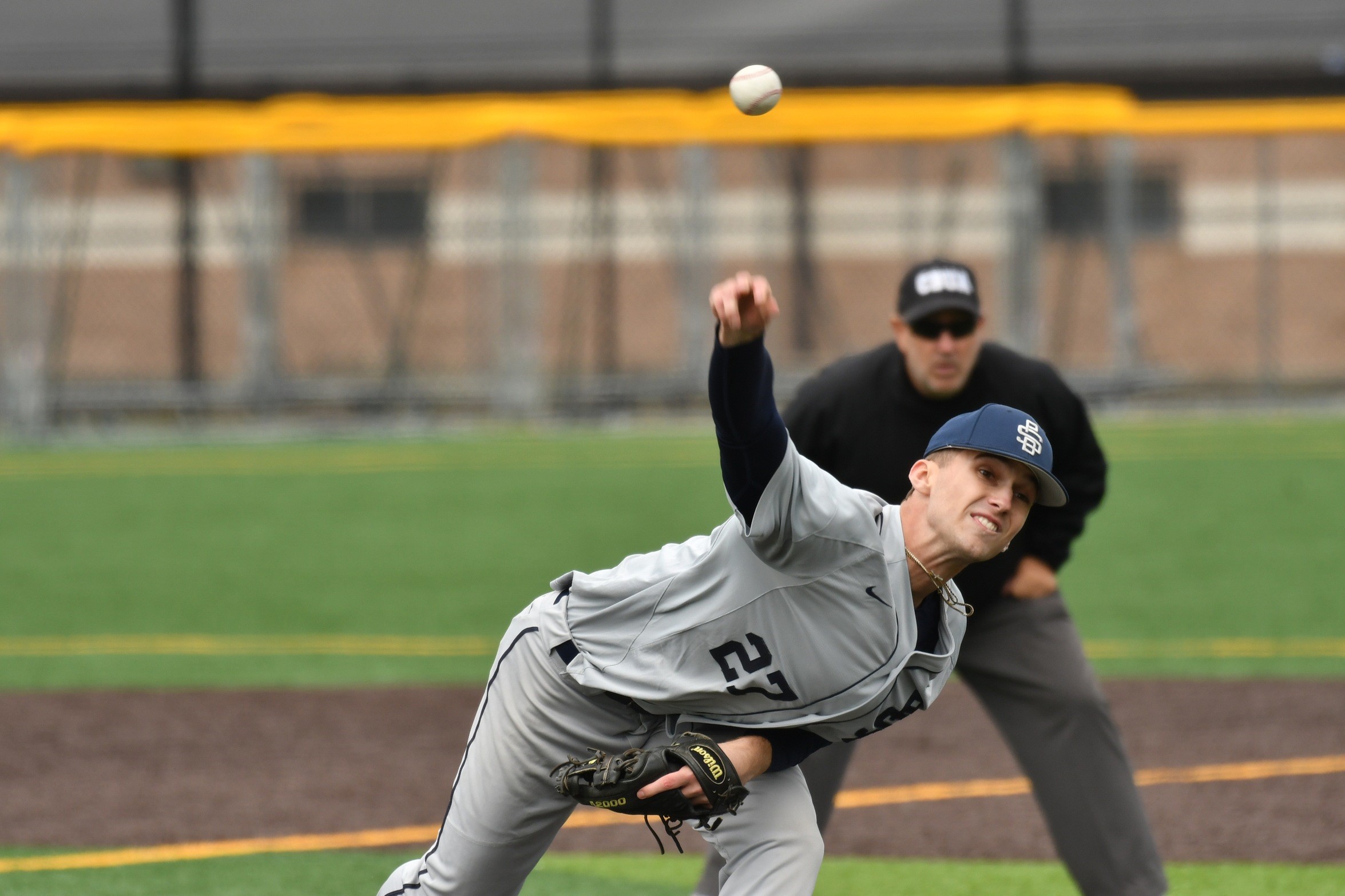 A pitcher for the Penn State Behrend baseball team throws the ball.