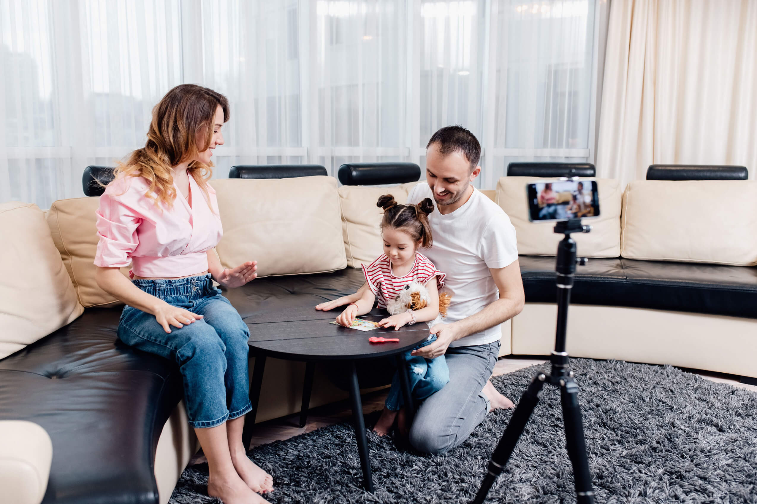 Family taking a photo of their child.