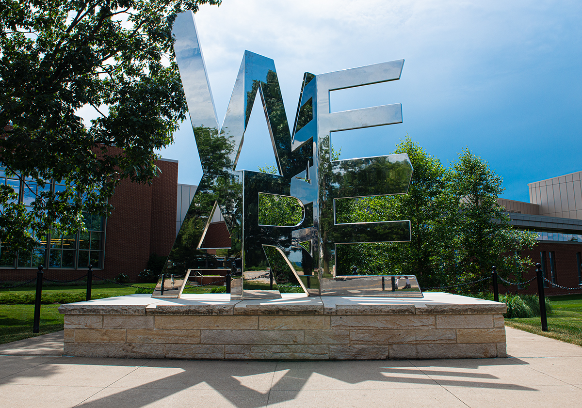 Metal sculpture of the words "We Are"