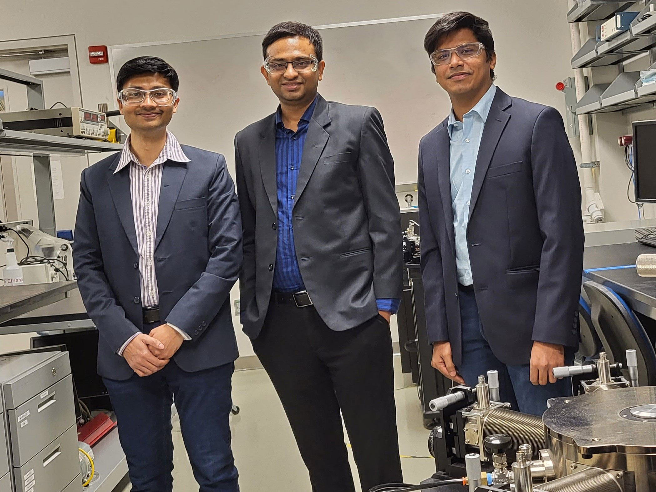 Three men in sport coats in a lab