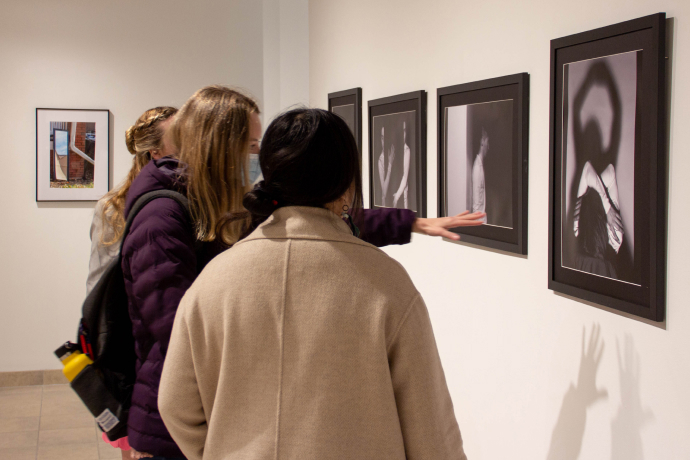 Visitors view works during the annual School of Visual Arts Graduate Research Exhibition in the HUB Galleries.