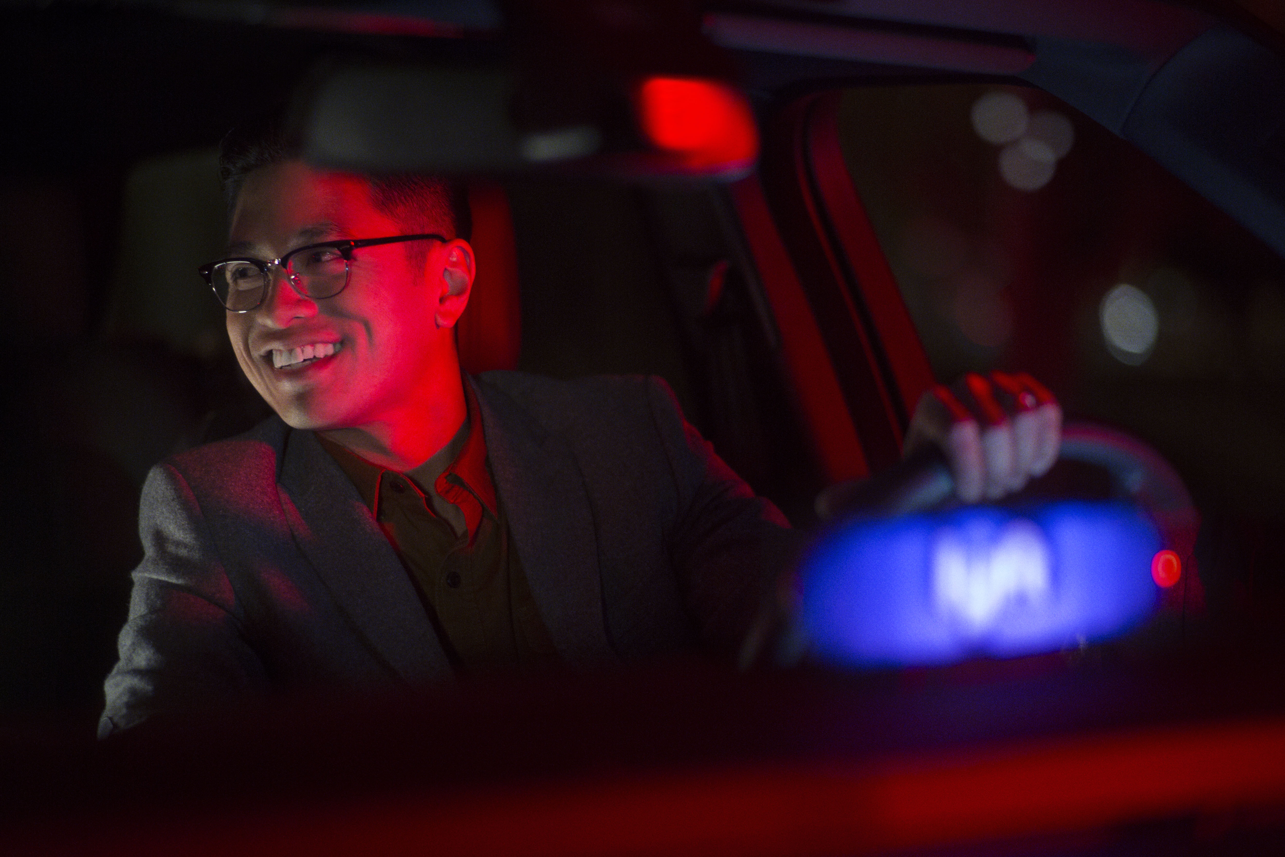 A man driving a vehicle displaying a Lyft badge