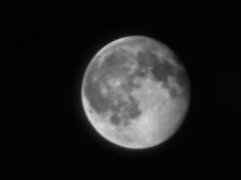 A black and white, close up photograph of the moon