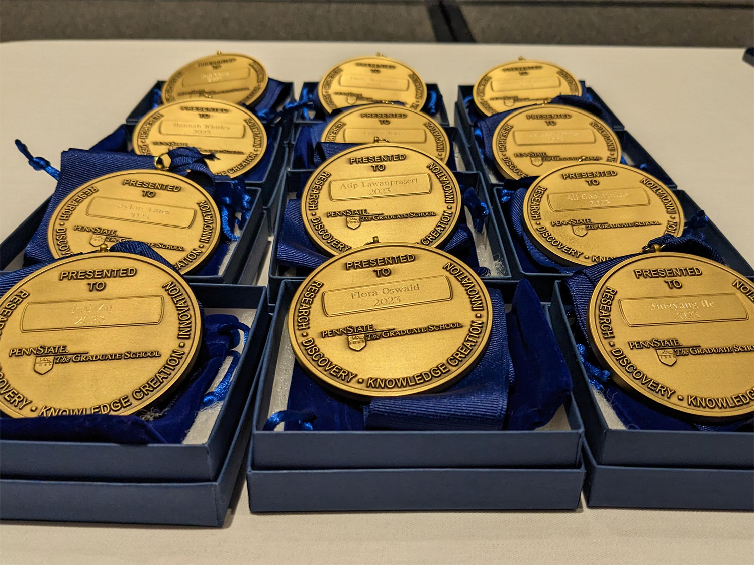 medals in boxes on a table