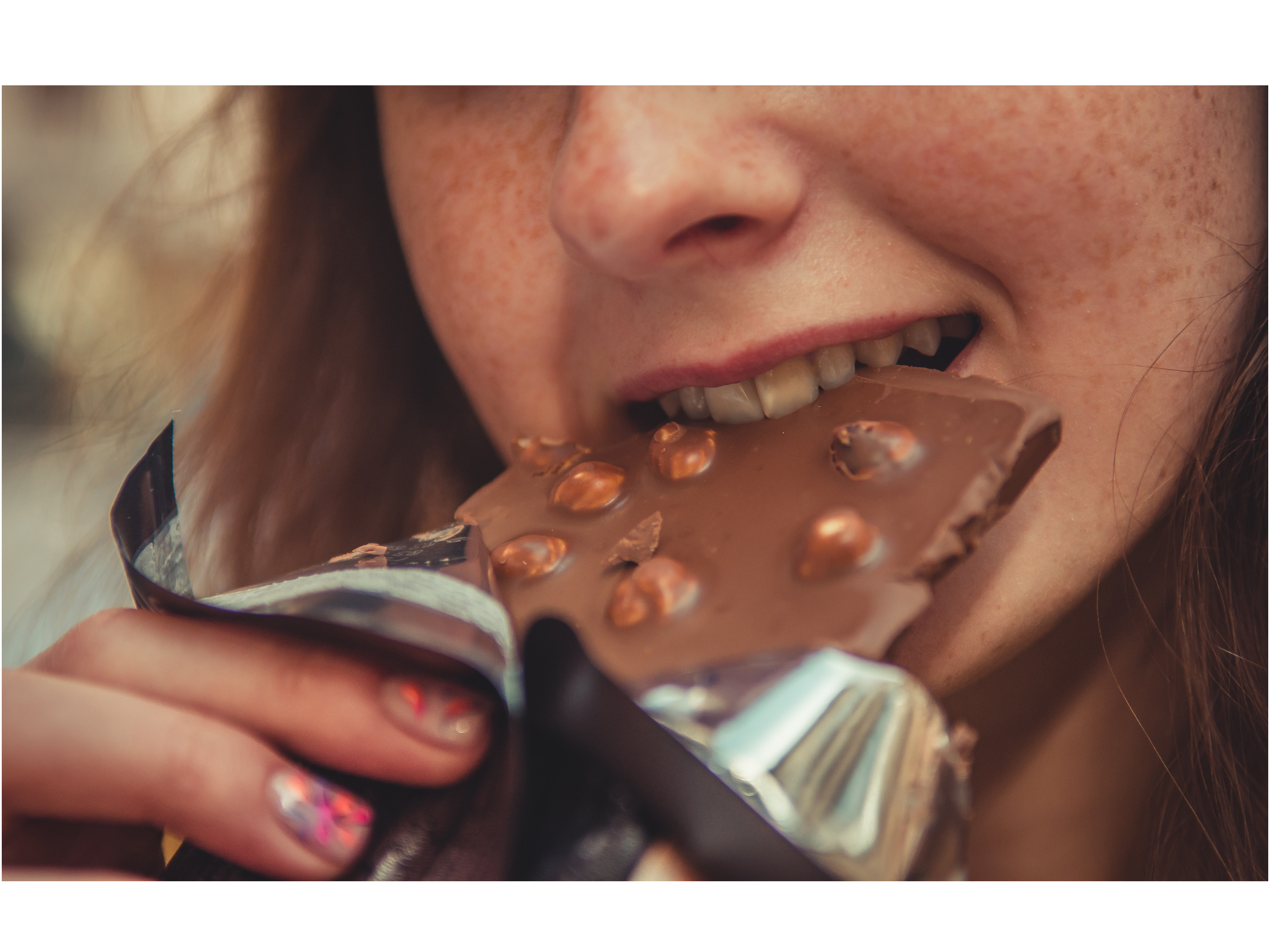 Woman eating a chocolate candy bar