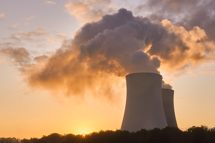 silhouette of a nuclear power plant at sunset