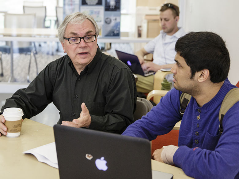 A professor speaks to a student at Penn State Berks