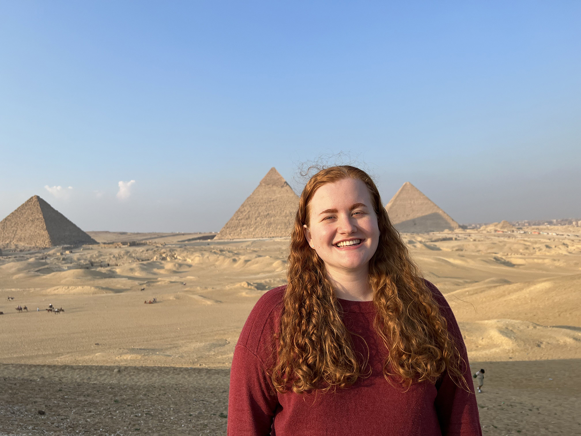 Casey Sennett at the Pyramids of Giza for embedded course ARAB 99/499: Youth Life in Egypt (December 2022)