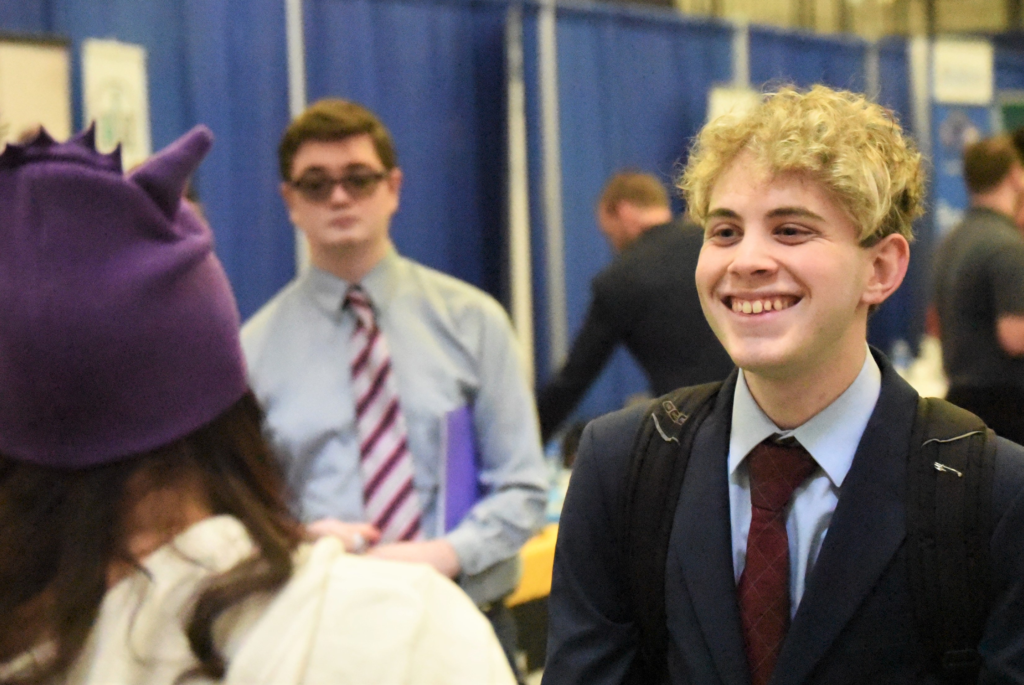 A student smiles while talking with a recruiter at Penn State Behrend's spring Career and Internship Fair.