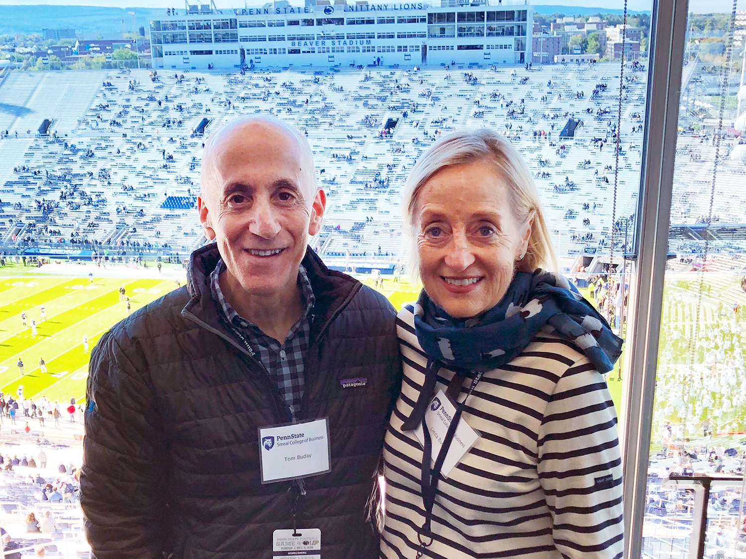 A photo of Tom and Linda Buday standing in a suite in Beaver Stadium