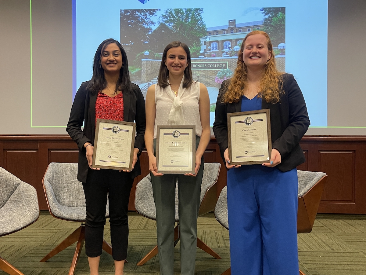 photos of three students standing and holding framed certificates