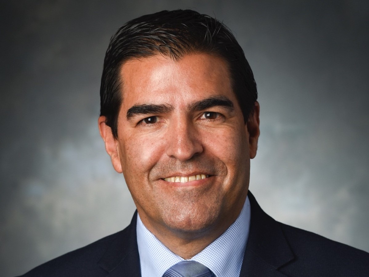 Headshot photo of Jean Paul Allain wearing a suit and tie