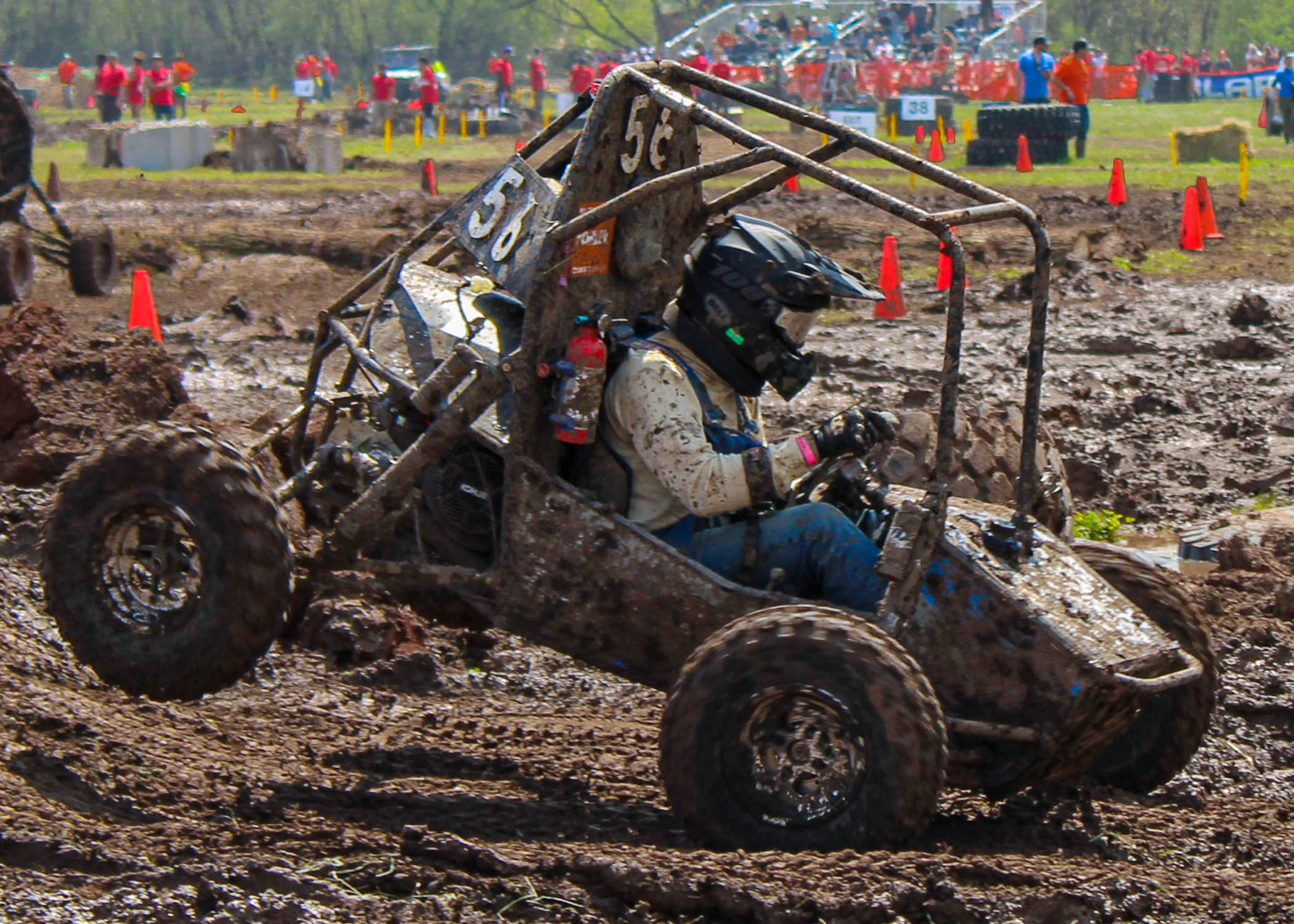 An all terrain vehicle being driven on a muddy course