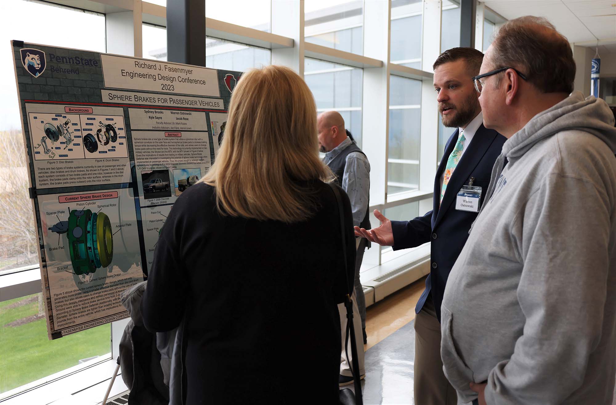 A student explains his capstone engineering project to visitors at Penn State Behrend's Fasenmyer Engineering Design Conference.