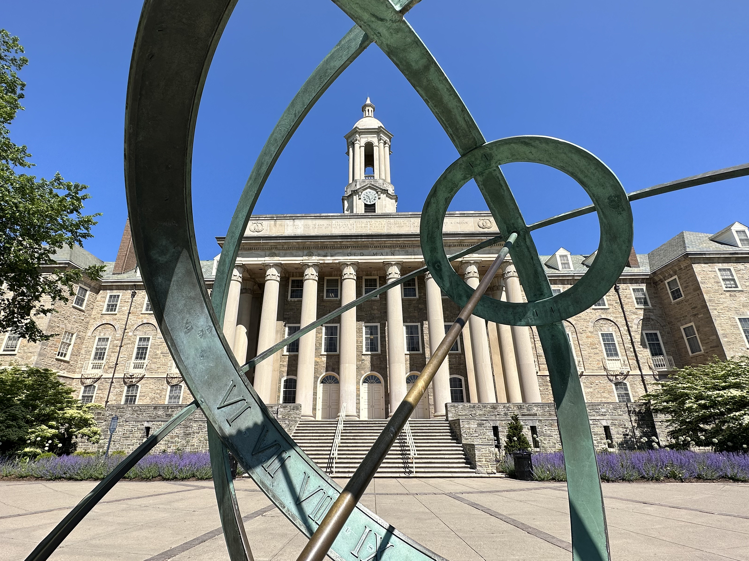 Wide shot of Old Main through Armillary Sphere